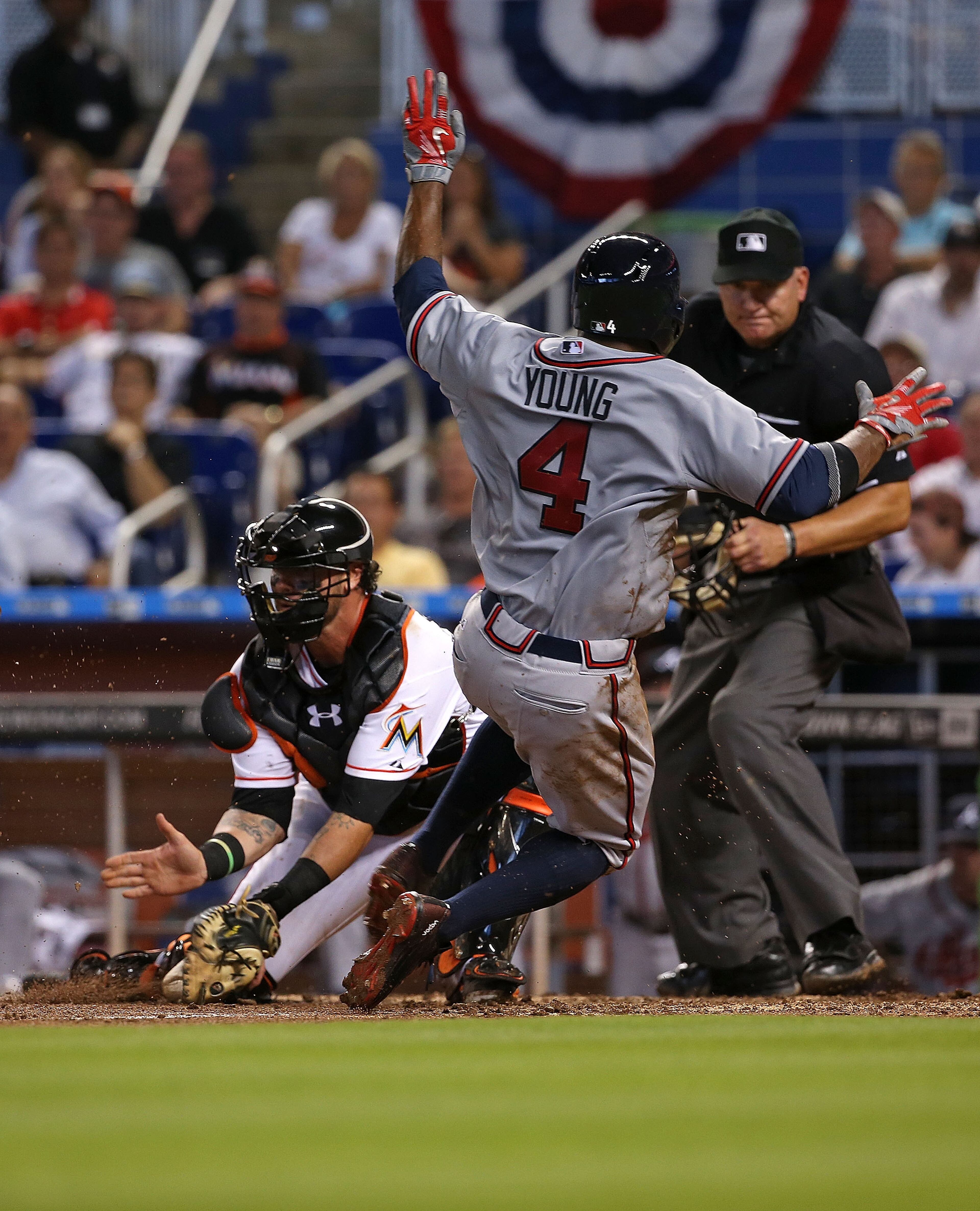 Eric Young Jr. #4 of the Atlanta Braves slides past Jarrod Saltalamacchia #39 of the Miami Marlins to score the go ahead run during Opening Day at Marlins Park on April 6, 2015 in Miami, Florida. The Braves won, 2-1. (Photo by Mike Ehrmann/Getty Images)