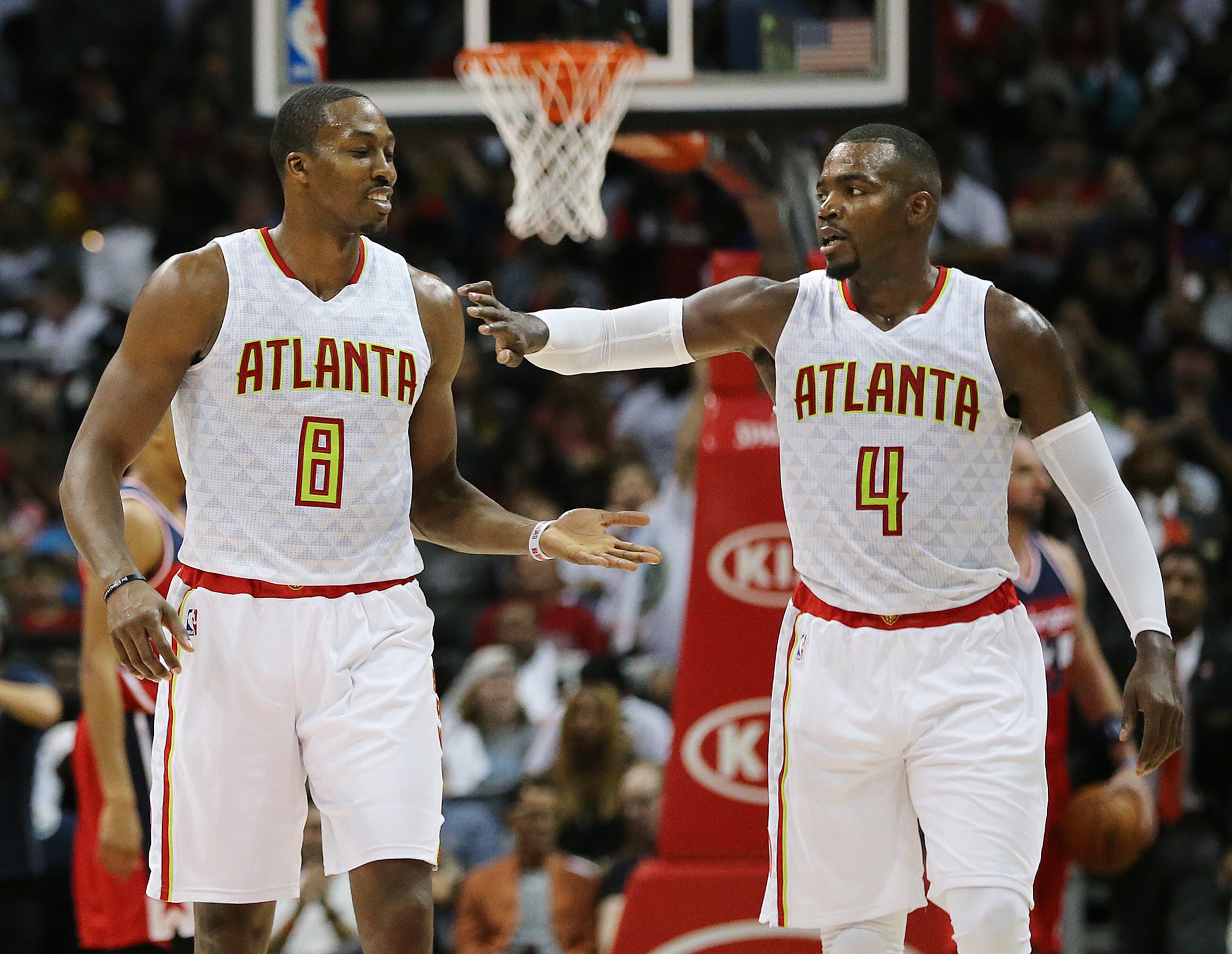 Hawks Dwight Howard and Paul Millsap exchange high fives pulling away from the Wizards in the final minutes of a 114-99 victory during the fourth period in the home opener of their NBA basketball game at Philips Arena on Thursday, Oct. 27, 2016, in Atlanta. Curtis Compton /ccompton@ajc.com