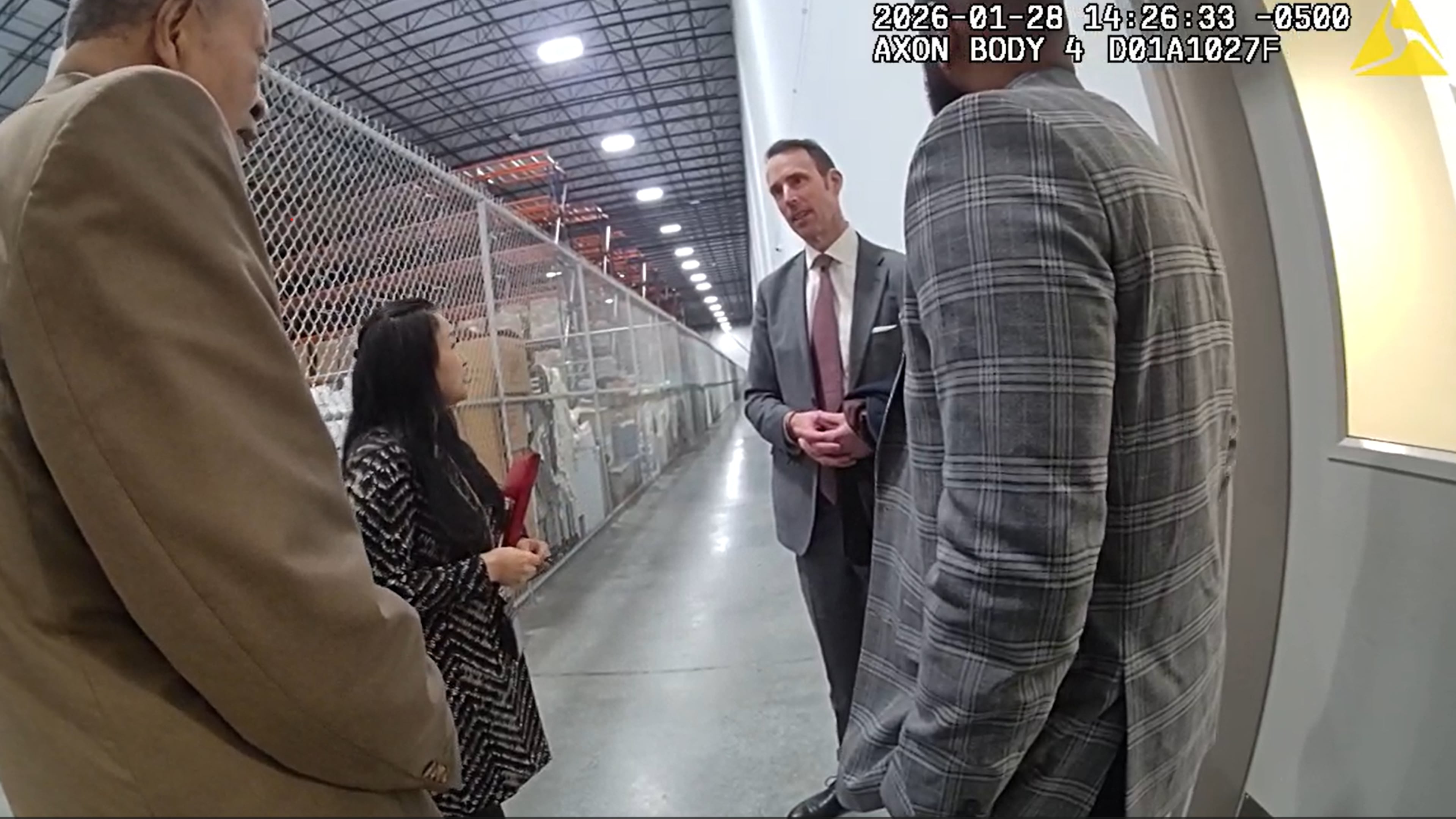 Body camera footage shows a conversation between Peter Ellis (right), the acting special agent in charge of the FBI's Atlanta field office, and Fulton County attorney Soo Jo during a raid of the county's election hub on Jan. 28, 2026. The FBI seized more than 650 boxes of 2020 ballots, which have long been a focus of discredited efforts to overturn the presidential election results. (Fulton County Police Department)