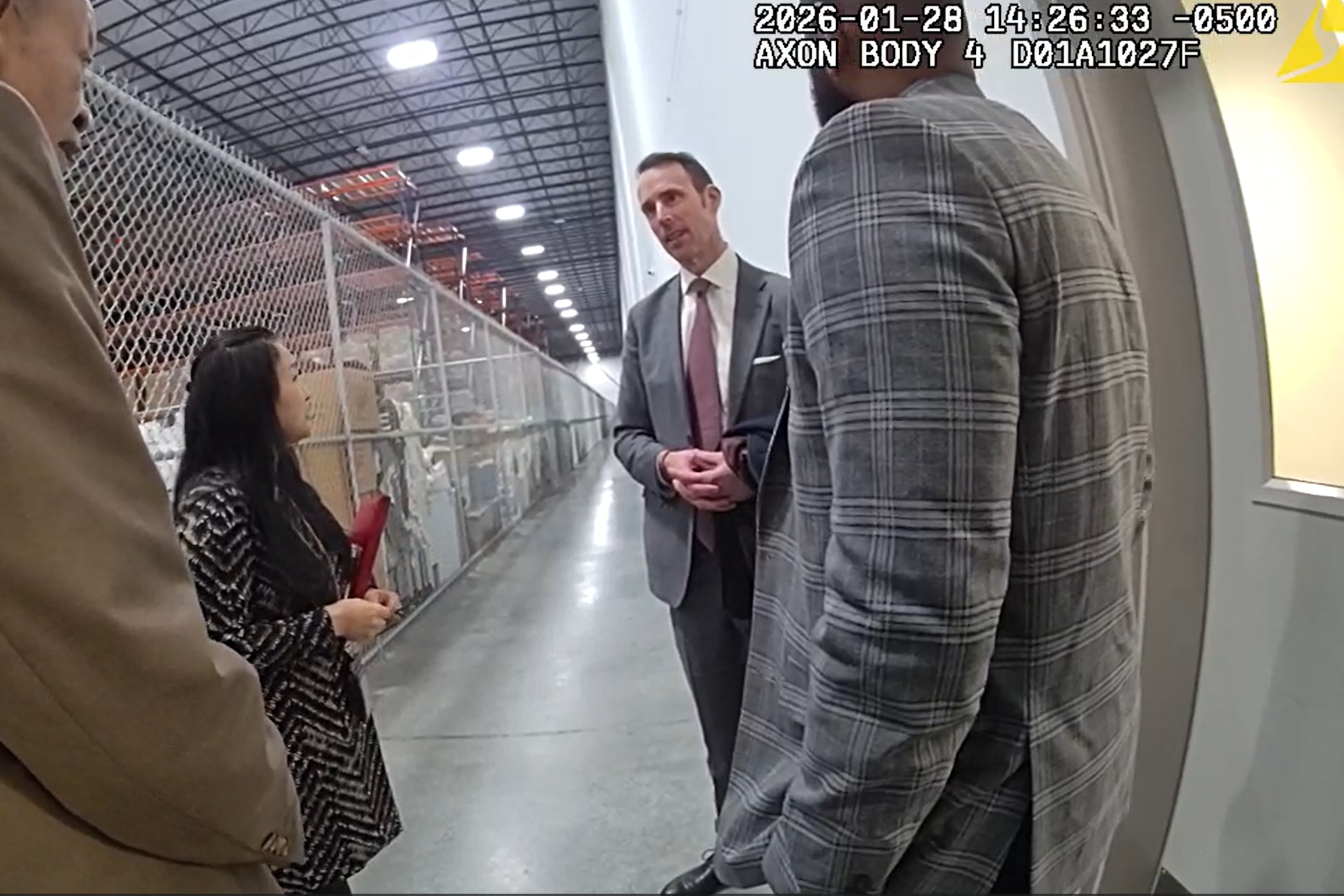 Body camera footage shows a conversation between Peter Ellis (right), the acting special agent in charge of the FBI's Atlanta field office, and Fulton County attorney Soo Jo during a raid of the county's election hub on Jan. 28, 2026. The FBI seized more than 650 boxes of 2020 ballots, which have long been a focus of discredited efforts to overturn the presidential election results. (Fulton County Police Department)