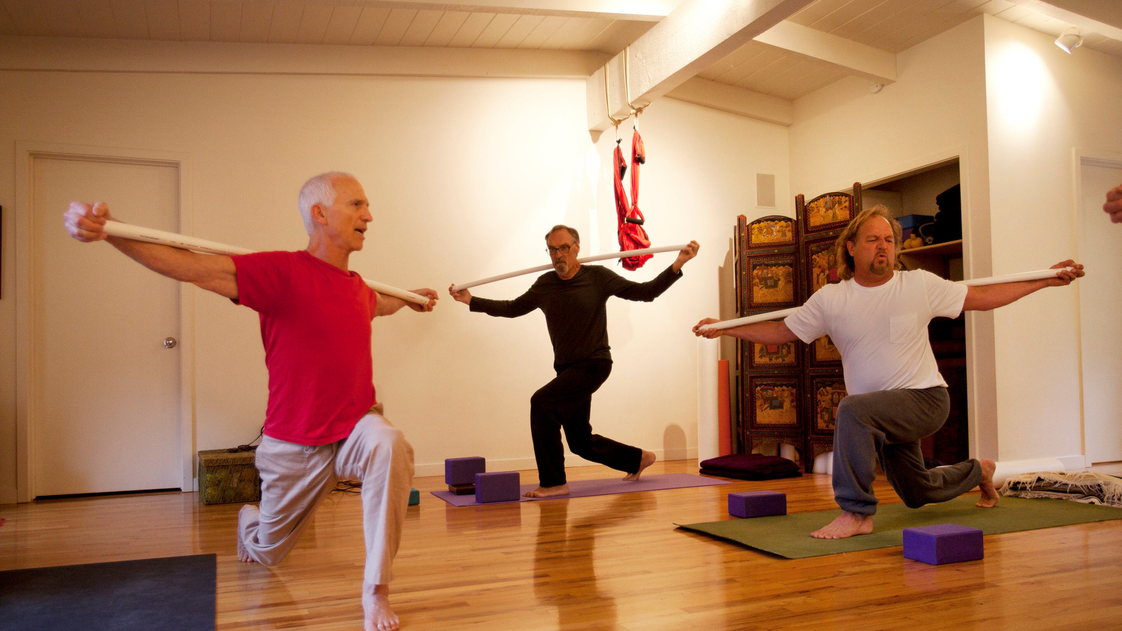 Paul Gould, left, teaches a yoga class at Namastay Yoga in Felton, Calif. Gould has a weekly class where he teaches a group of several men -- regulars who've become friends, including Jim Scheer, center, and Jon Troutner, right. (Patrick Tehan/Bay Area News Group/TNS)