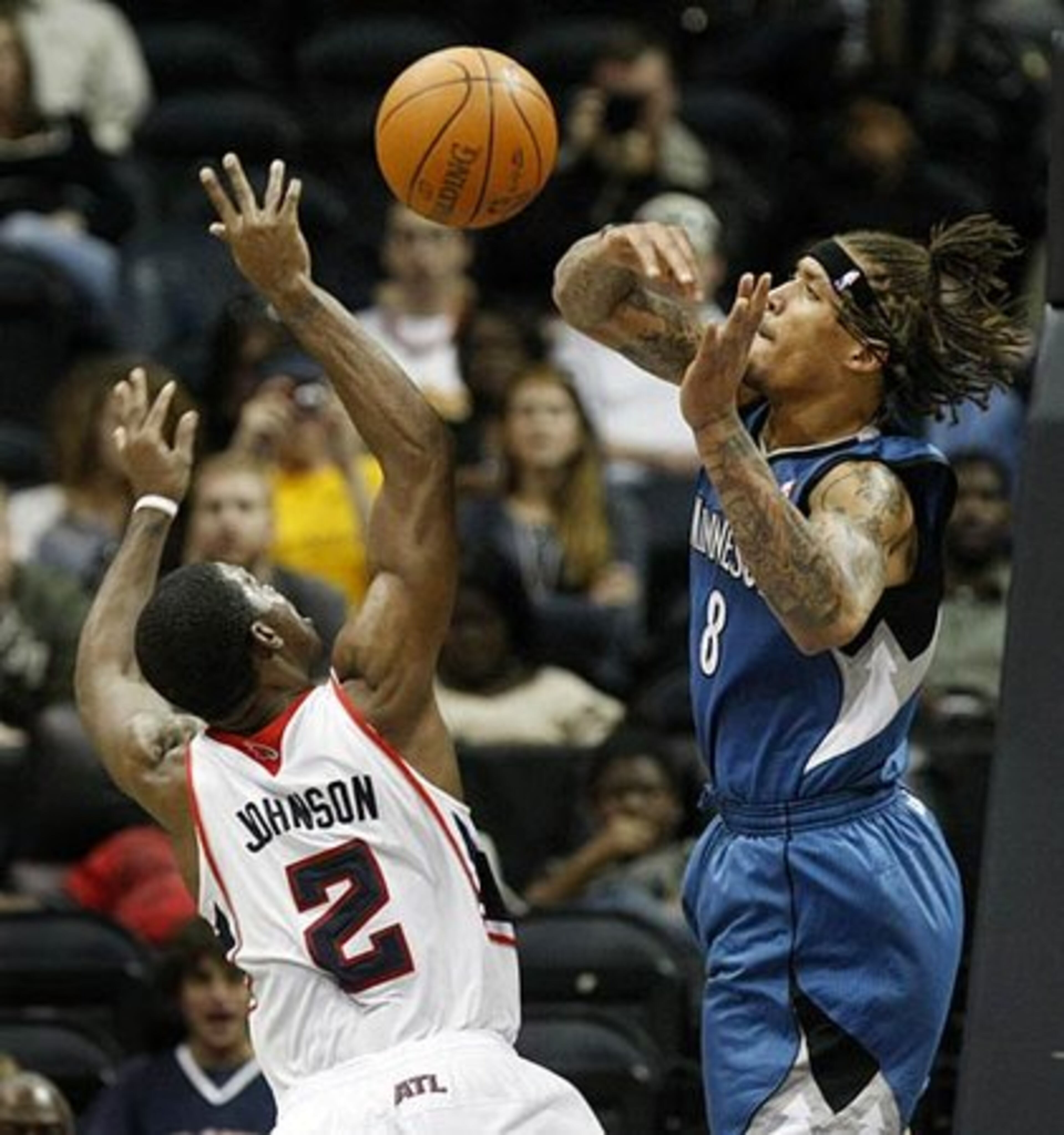 Hawks guard Joe Johnson is fouled by Minnesota Timberwolves forward Michael Beasley while shooting during 2nd half action.
