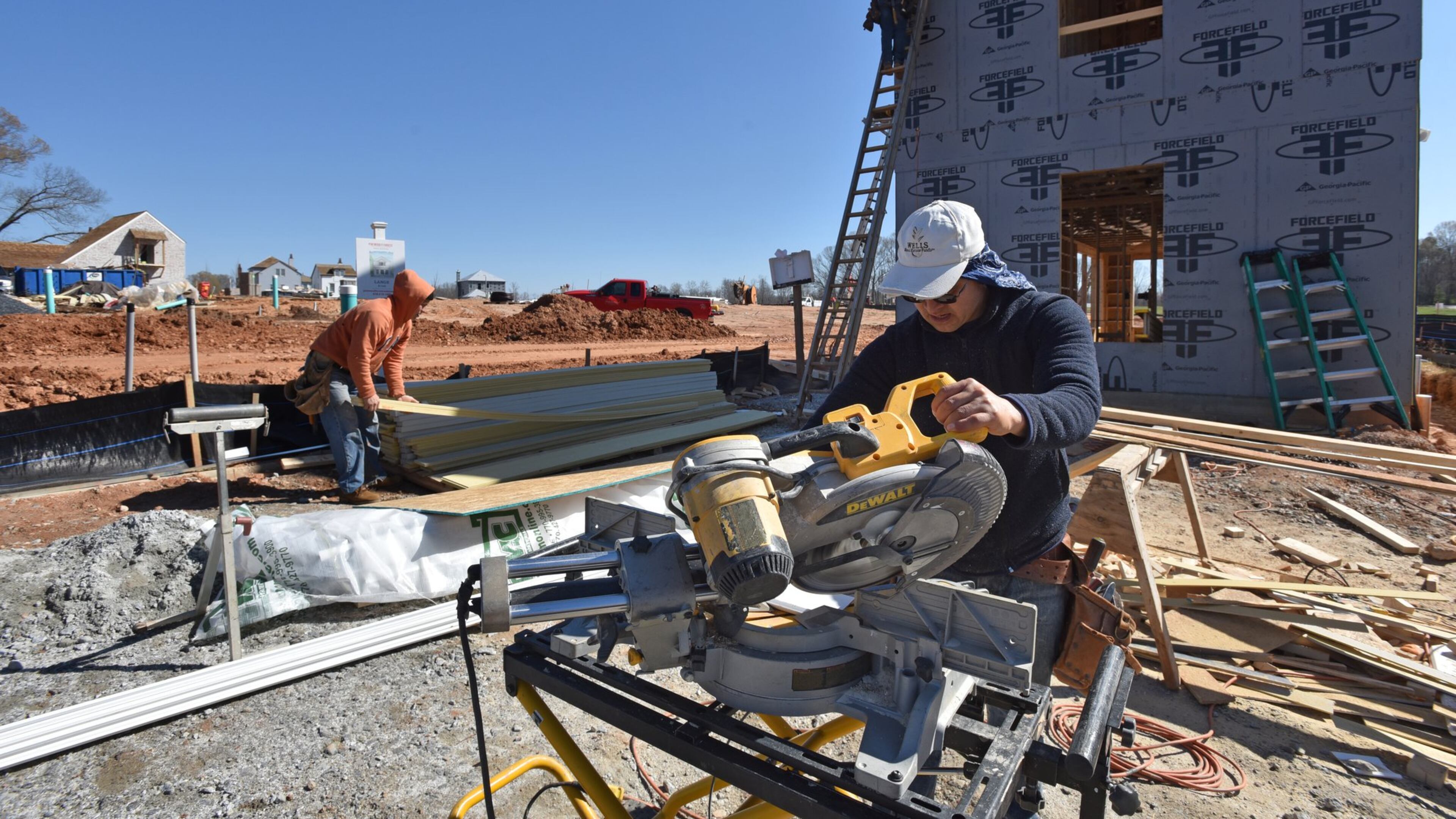 Construction hiring was strong last month, according to the Labor Department. Here, construction crews work recently on Pinewood Forest, a mixed-use development, in Fayetteville. HYOSUB SHIN / HSHIN@AJC.COM