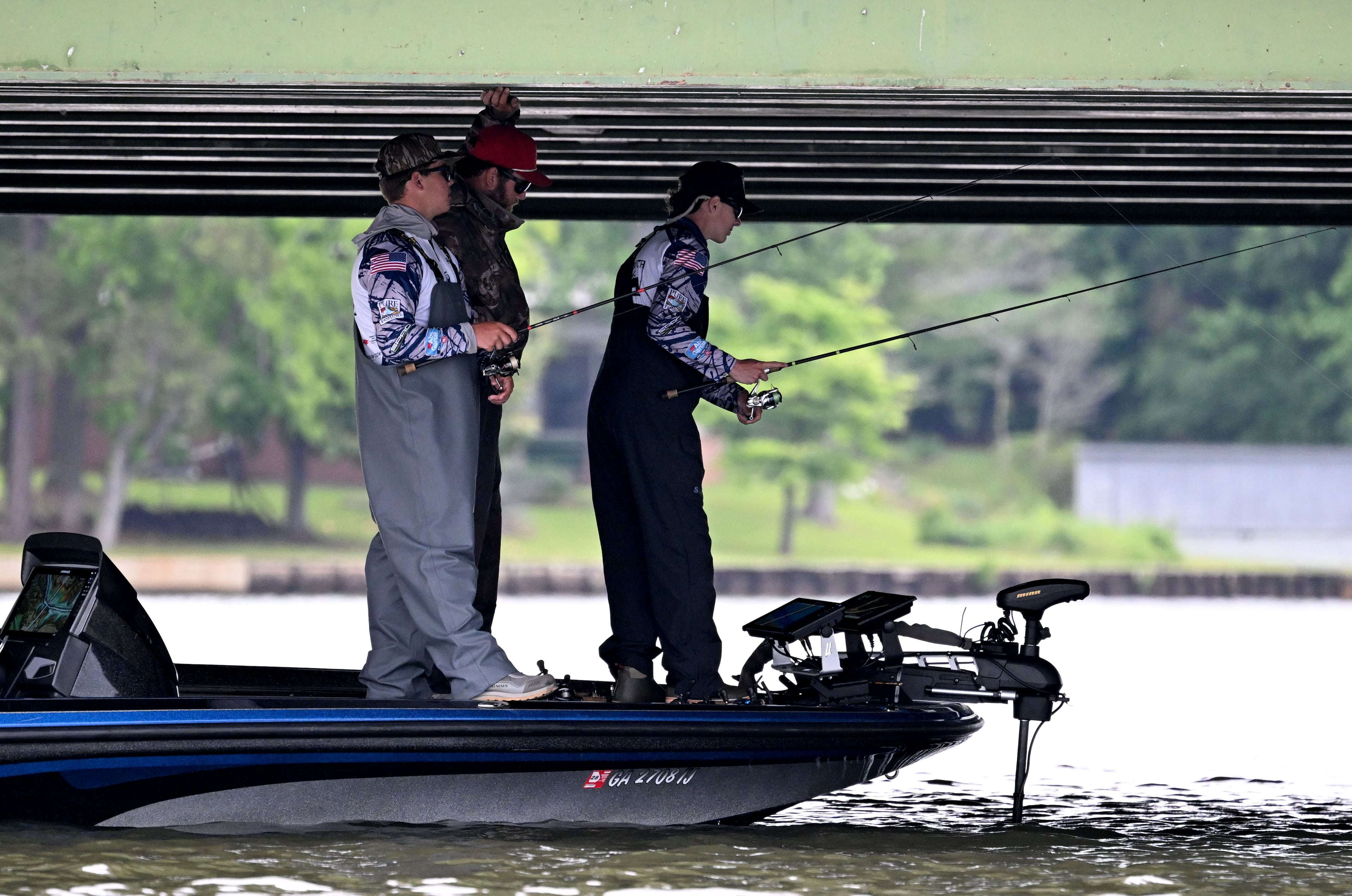 Student anglers Robert Ray and Sam Murfree of Fellowship Christian pick a spot out of the sun to see how many fish they can catch. (Hyosub Shin/AJC)