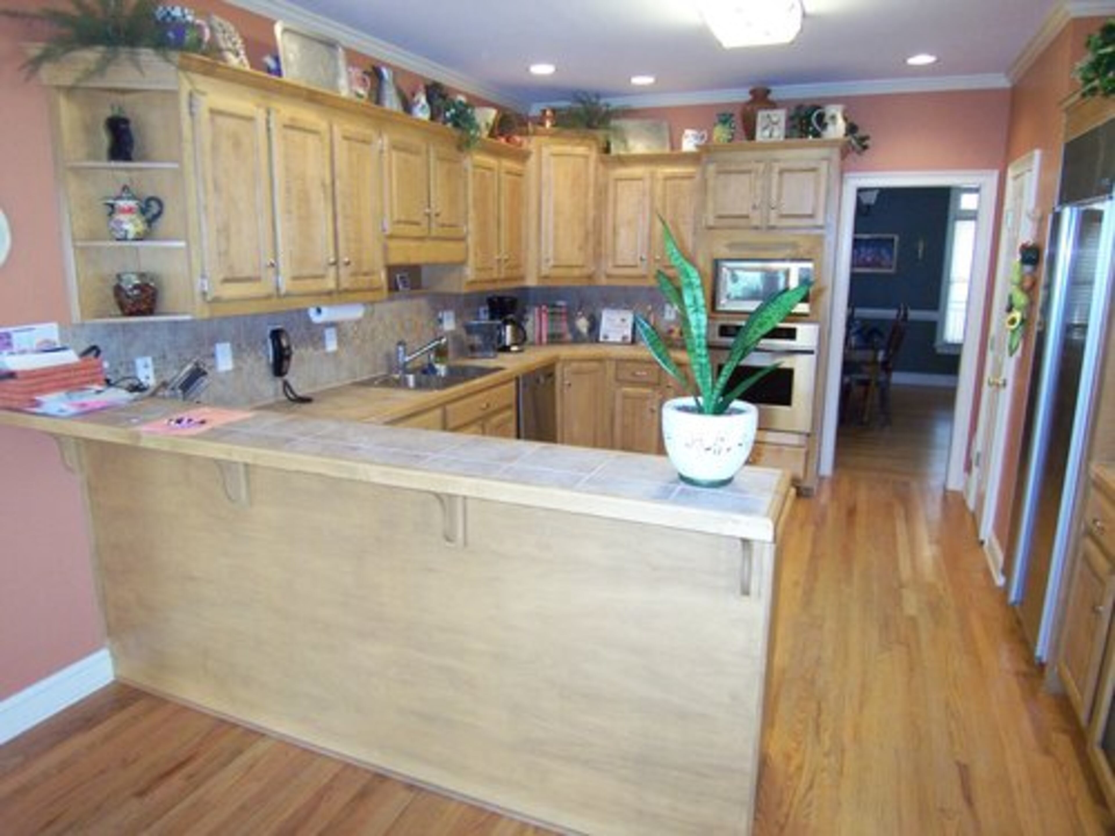 Too many accessories, especially on the top of the cabinets, make this kitchen feel cluttered.