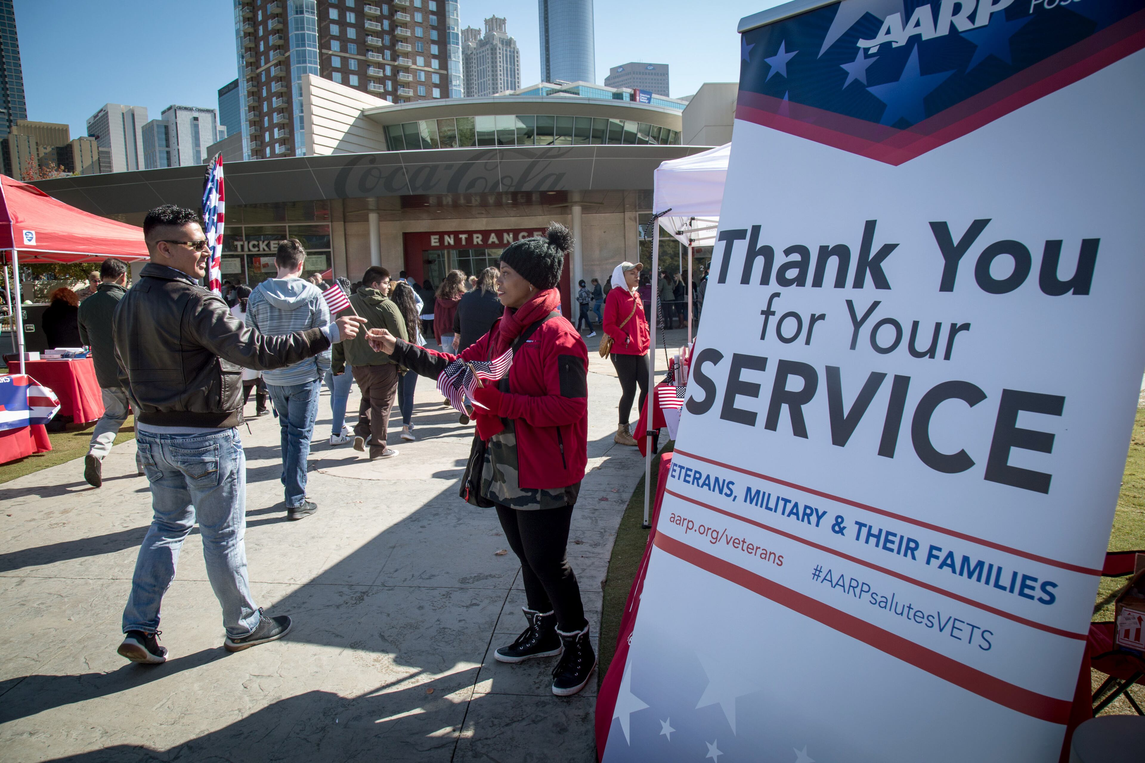 AARP employee Jil Hinds hands out American flags during the Veterans Festival that started after the 37th Annual Atlanta Veterans Day Parade on Saturday, November 10, 2018, in Atlanta. (Photo: STEVE SCHAEFER / SPECIAL TO THE AJC)