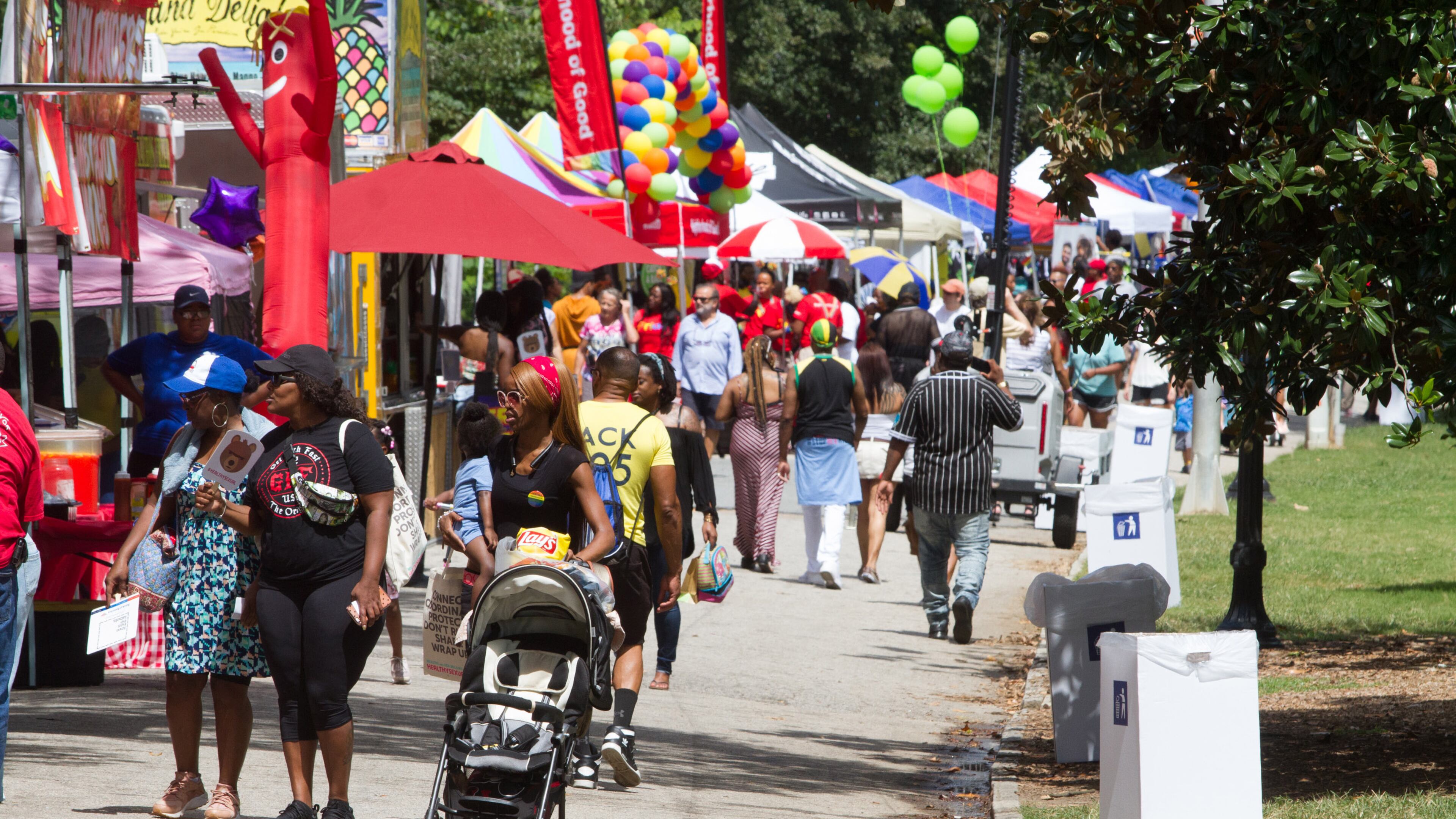 People walk by and visit the vendor booths during the Pure Heat Community Festival celebrating Atlanta Black Pride Weekend in Piedmont Park on Sunday, September 2, 2018. (Photo: STEVE SCHAEFER / SPECIAL TO THE AJC)