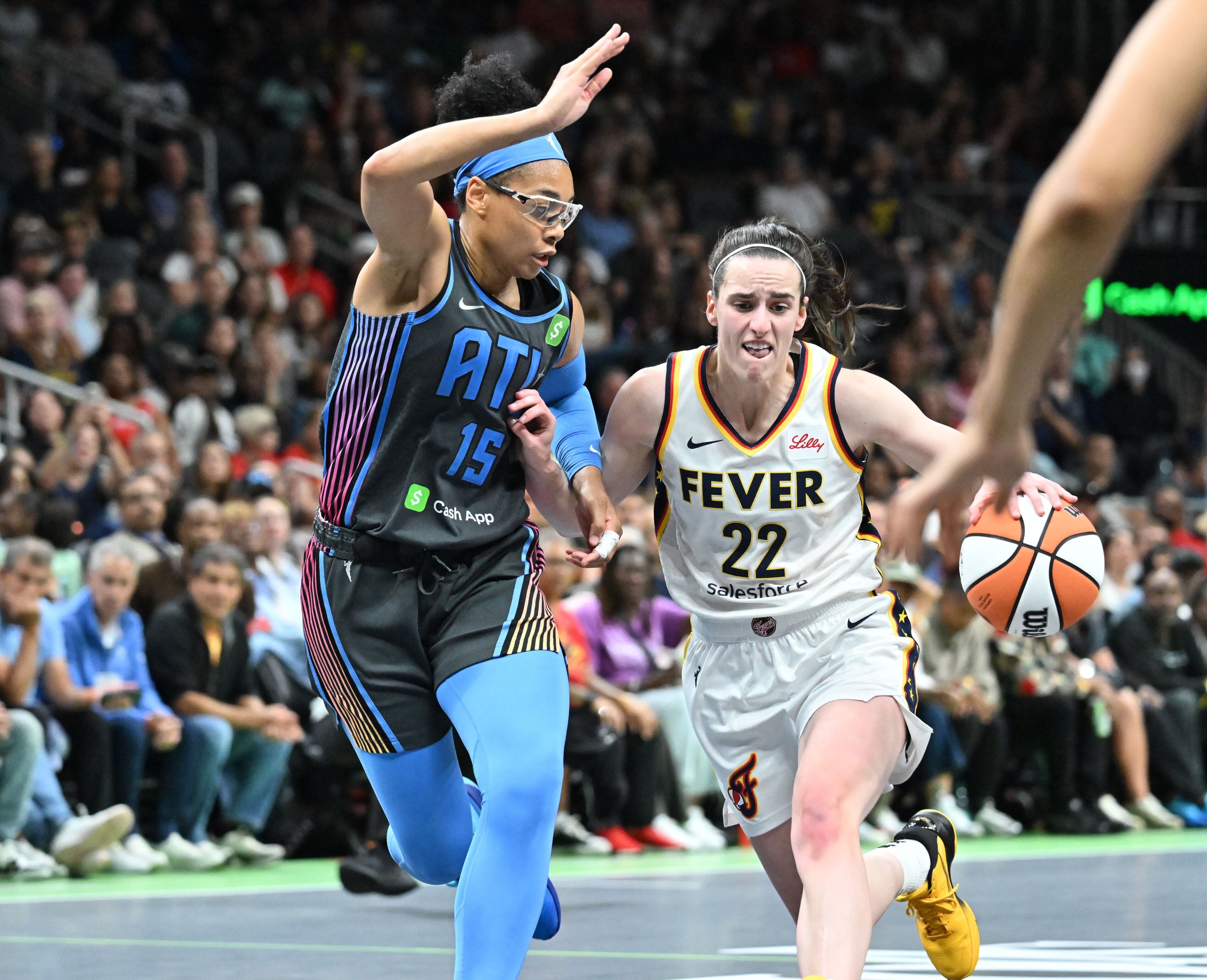 Indiana Fever guard Caitlin Clark (22) drives against Atlanta Dream guard Allisha Gray (15) during the second half in Atlanta Dream’s home opener at State Farm Arena, Thursday, May 22, 2025, in Atlanta. Indiana Fever won 81-76 over Atlanta Dream. (Hyosub Shin / AJC)