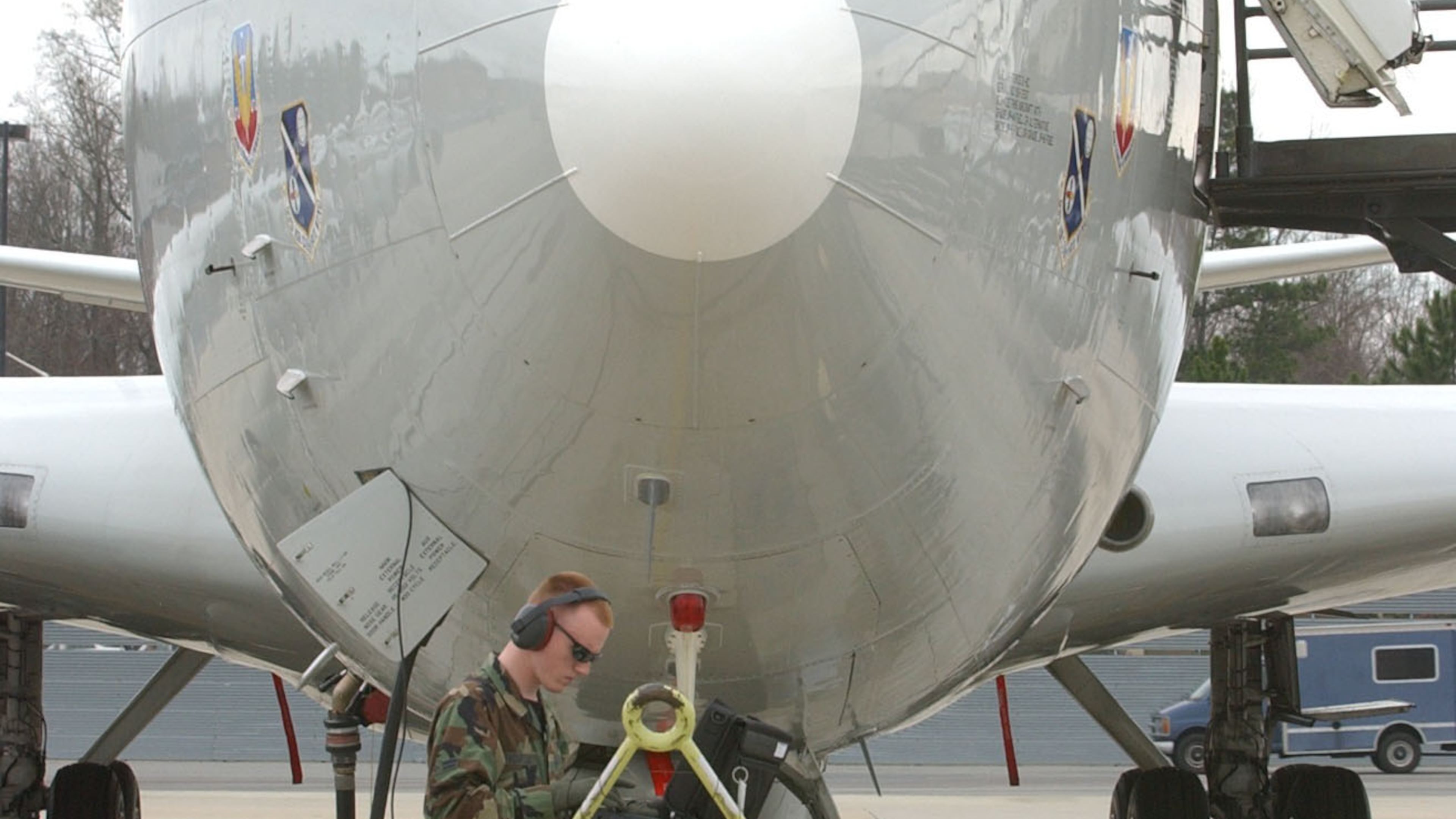 An airman uses a computer to review Electronic Technical Data used to track onboard tasks by the crew of a JSTARS surveillance plane behind him on the tarmac at Warner Robins Air Force Base in this photo from March 2003. Congress and the Pentagon have big plans in the years ahead for replacing this aging but popular fleet of 16 planes, which are based exclusively at Robins and have been in use by the Air Force for roughly 25 years. But it would have to get through a congressional budget process snarled in partisan politics. (Kimberly Smith/AJC staff)