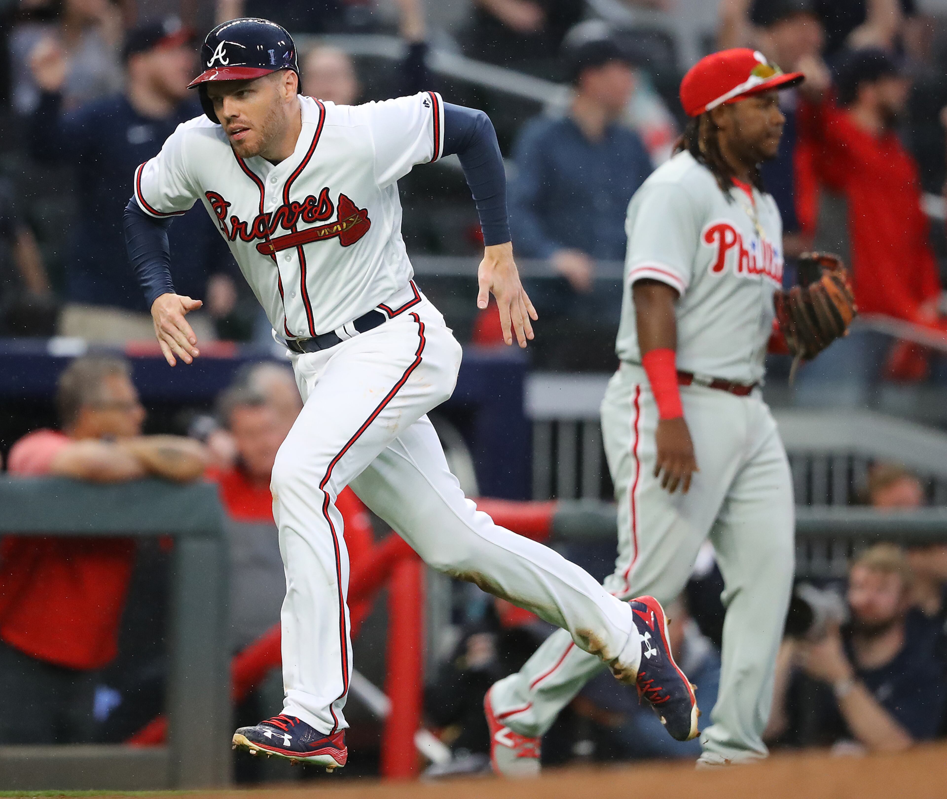 March 29, 2018 Atlanta: Atlanta Braves Freddie Freeman scores from second base on a wild pitch that advanced him to third and a errant throw to third sending him home during the eight inning against the Phillies in a MLB baseball home opening game on Thursday, March 29, 2018, in Atlanta. Curtis Compton/ccompton@ajc.com