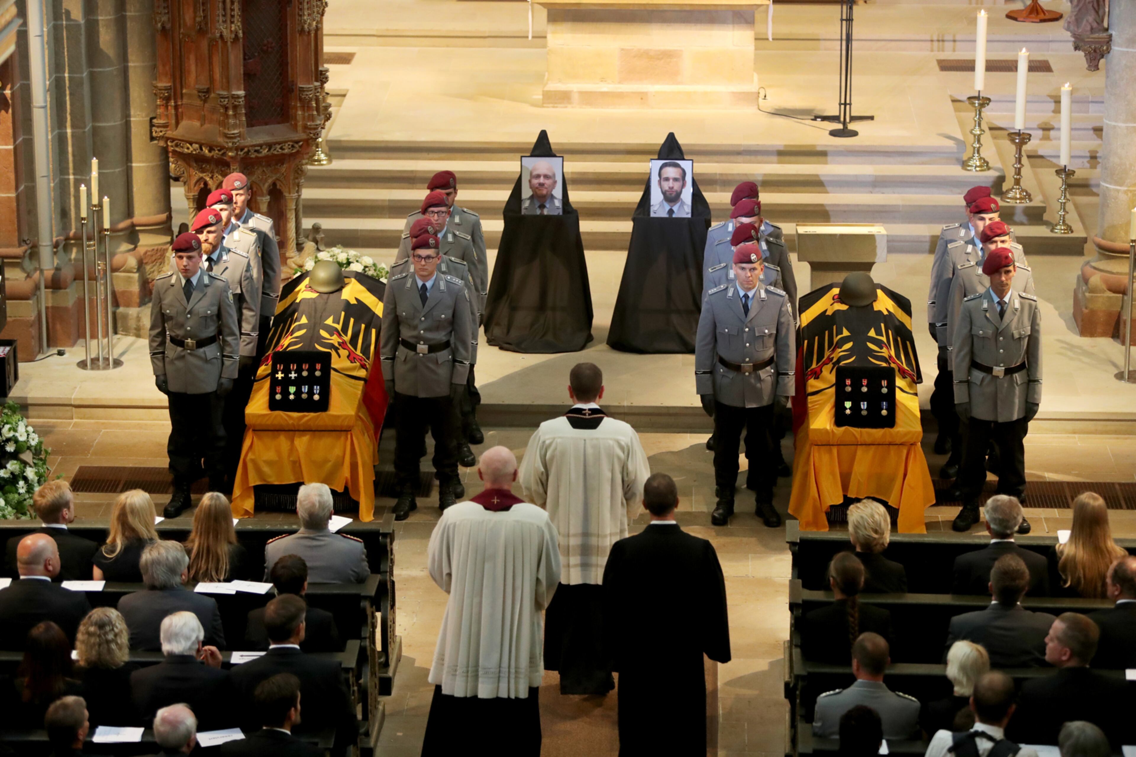 FRITZLAR, GERMANY - AUGUST 03: Mourners attend a funeral service for two deceased German soldiers at Fritzlar Cathedral on August 3, 2017 in Fritzlar, Germany. The two pilots were killed on July 26 when their Tiger attack helicopter crashed during a combat support mission in Mali. The Bundeswehr is still investigating the cause of the crash. Germany is participating in the international peacekeeping mission in Mali. (Photo by Tyler Larkin - Pool/Getty Images)