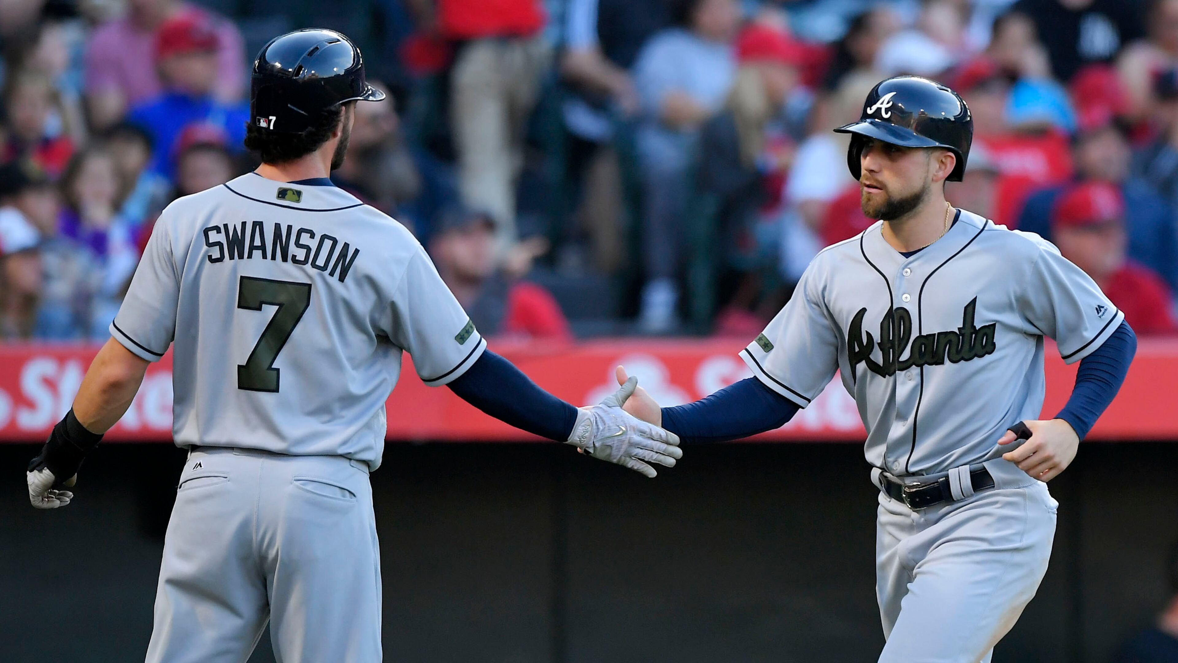 Atlanta Braves’ Dansby Swanson (left) and Ender Inciarte congratulate each other after they scored on a ground-rule double by Matt Adams during the third inning against the Los Angeles Angels, Monday, May 29, 2017, in Anaheim, Calif. (AP Photo/Mark J. Terrill)