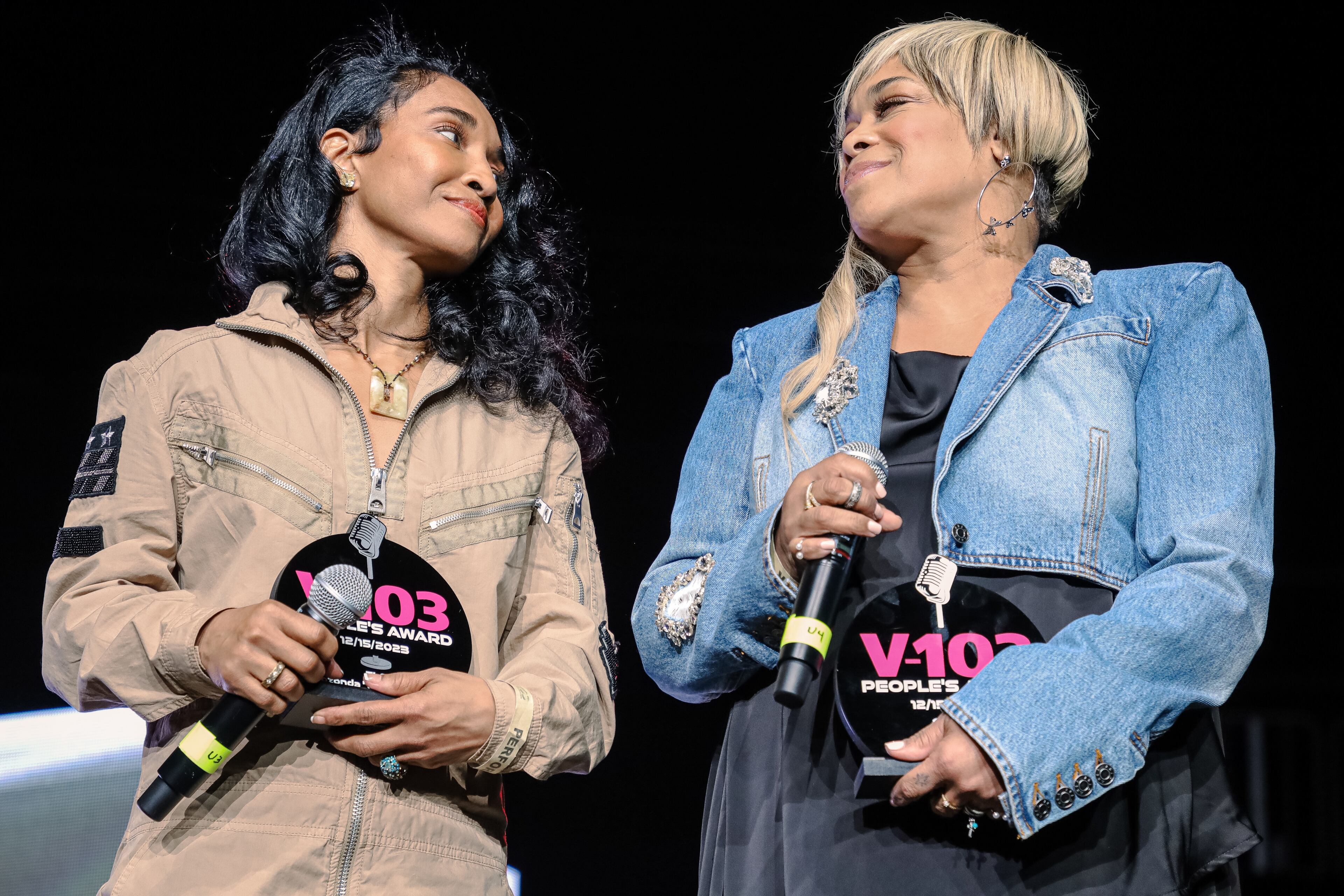Tionne "T-Boz" Watkins and Rozonda "Chili" Thomas, members of TLC, receive the V103 People’s Award on Friday, Dec. 15, 2023, at State Farm Arena for V103’s Winterfest. (Kymani Culmer for The Atlanta Journal-Constitution)