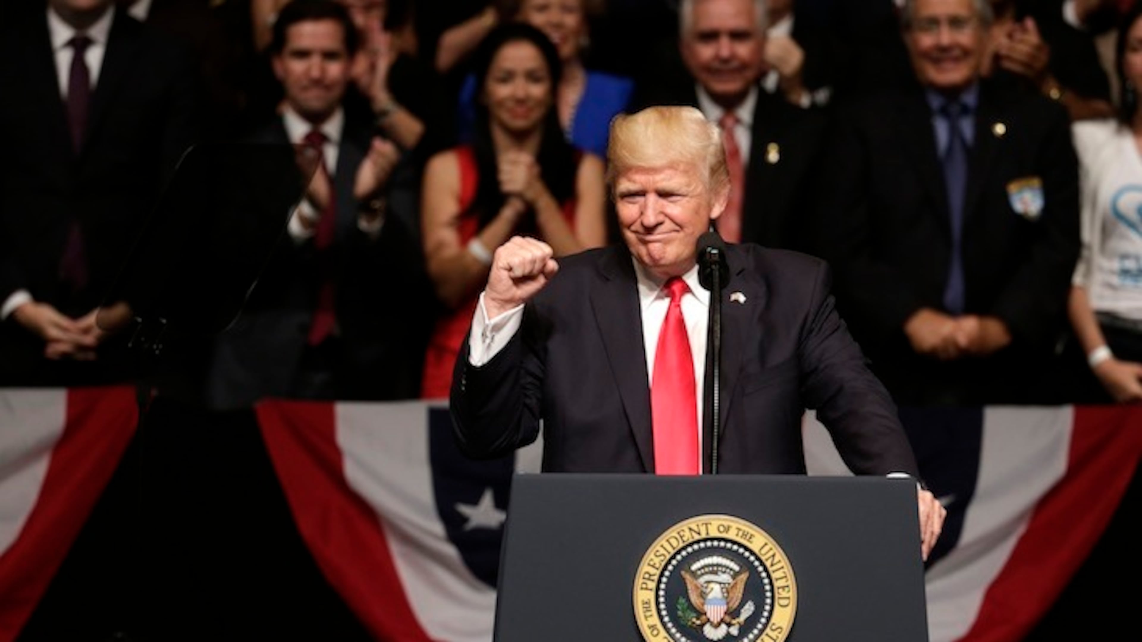 President Donald Trump clenches his fist as he announces a revised Cuba policy aimed at stopping the flow of U.S. cash to the country's military and security services while maintaining diplomatic relations, Friday, June 16, 2017, in Miami. (AP Photo/Lynne Sladky)