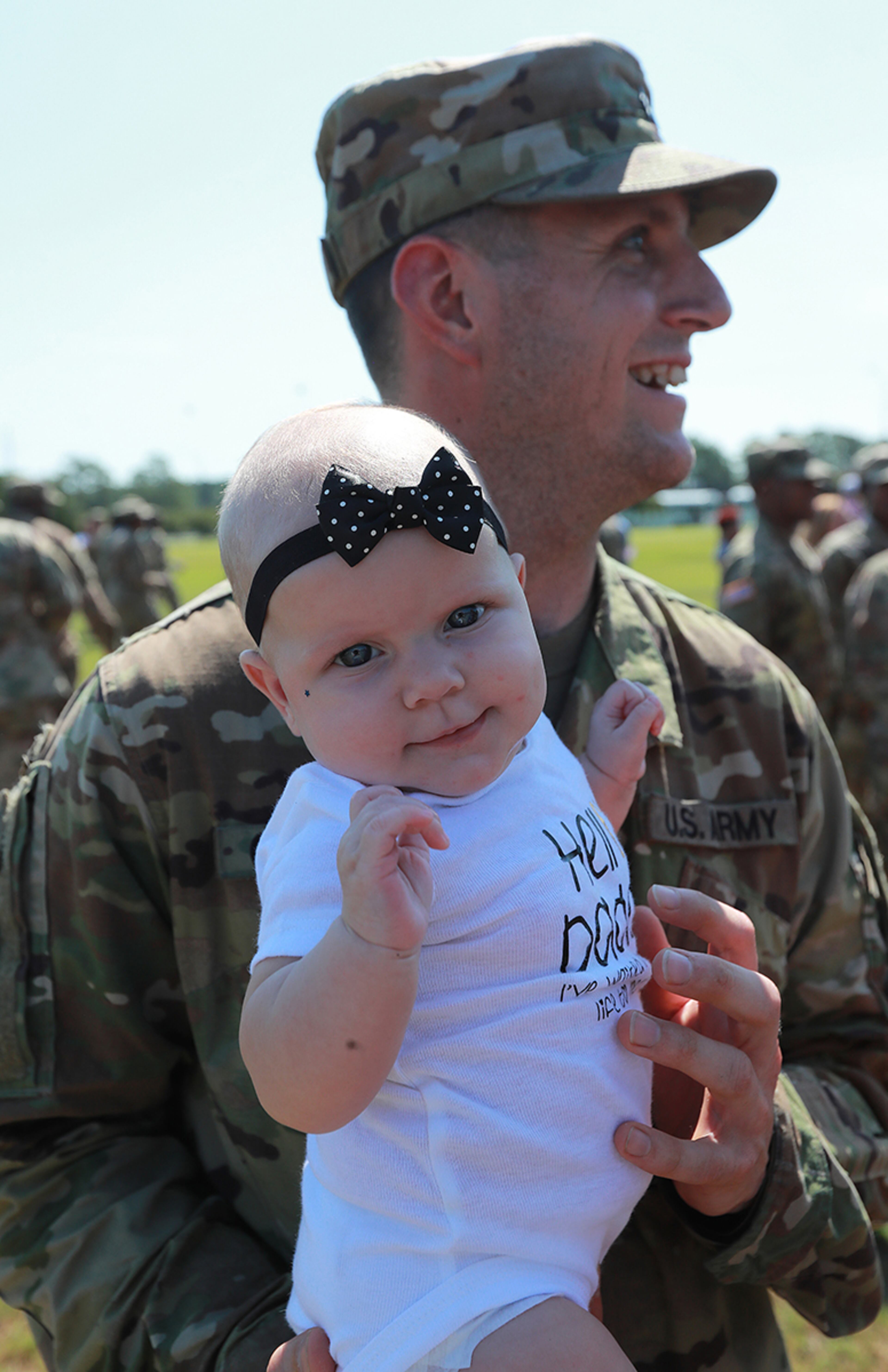 July 30, 2019 Fort Stewart: Sergeant Jason Calahan reacts to seeing his 4-month old daughter Zoey for the first time as soldiers of the 48th Infantry Brigade Combat Team representing units from across the state return home from deployment to Afghanistan in support of Operation Resolute Support at Cottrell Field on Tuesday, July 30, 2019, in Fort Stewart. Curtis Compton/ccompton@ajc.com