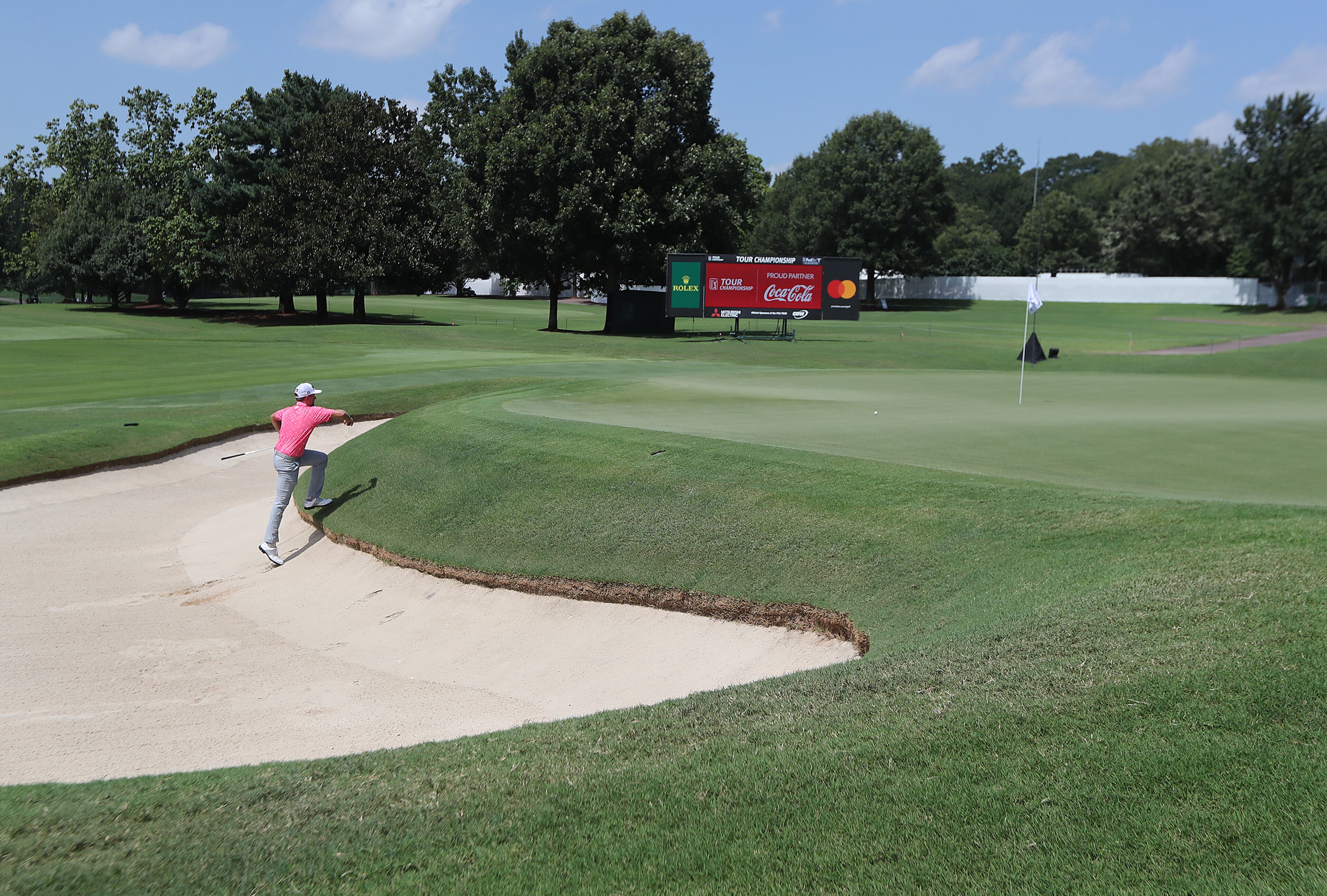 Webb Simpson has the course almost all to himself as he climbs the bank after hitting from the bunker to the 18th green during his practice round for the Tour Championship at East Lake Golf Club on Thursday, Sept. 3, 2020 in Atlanta. “Curtis Compton / Curtis.Compton@ajc.com”