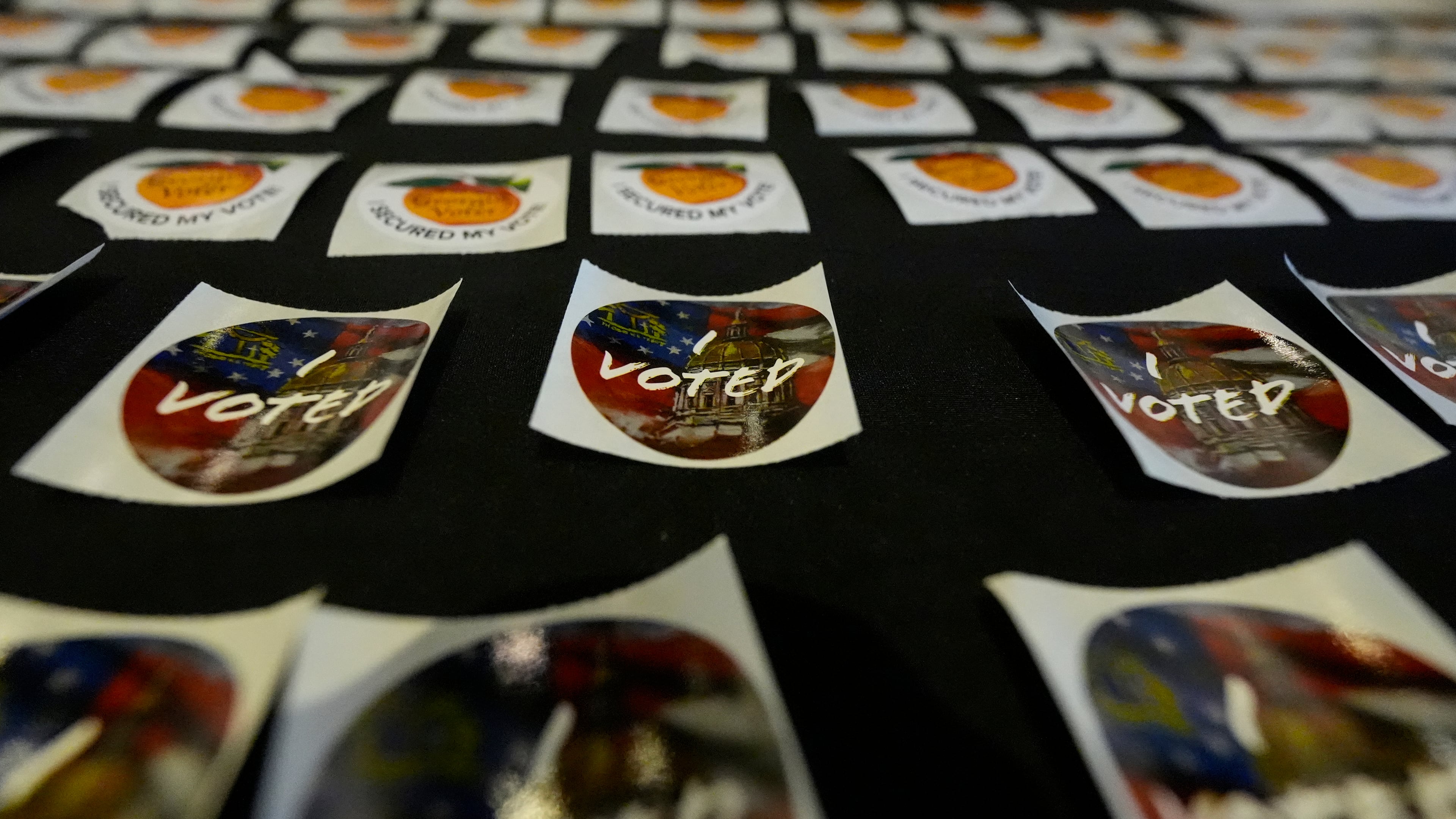 Stickers are seen at the Southwest Arts Center voting site in Atlanta on the first day for early voting in Georgia, Tuesday, Oct. 13, 2026. (Mike Stewart/AP)