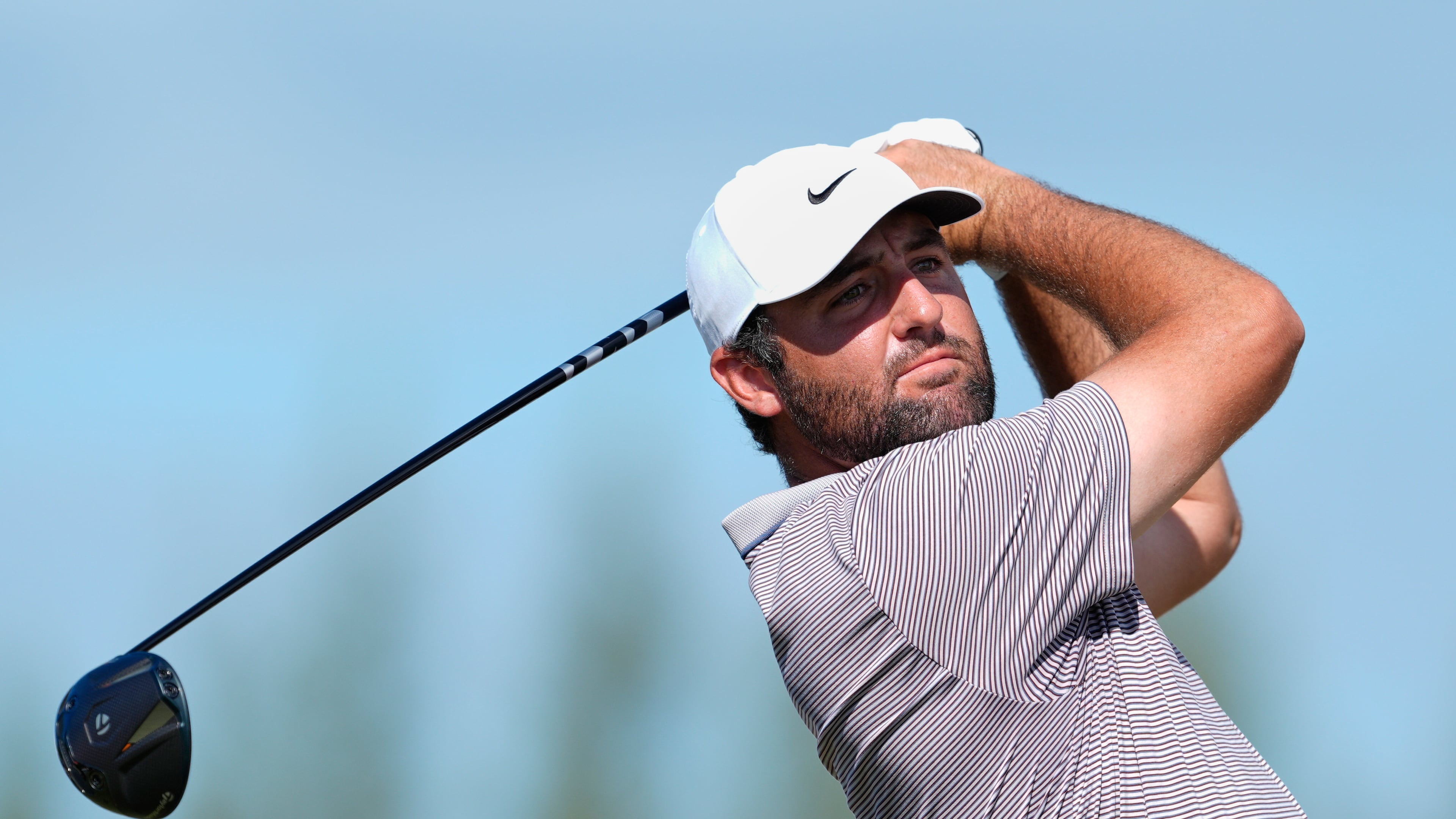 FILE - Scottie Scheffler, of the United States, watches his tee-off at the fourth hole during the final round of the Hero World Challenge PGA Tour at the Albany Golf Club in New Providence, Bahamas, Dec. 7, 2025. (AP Photo/Fernando Llano, File)