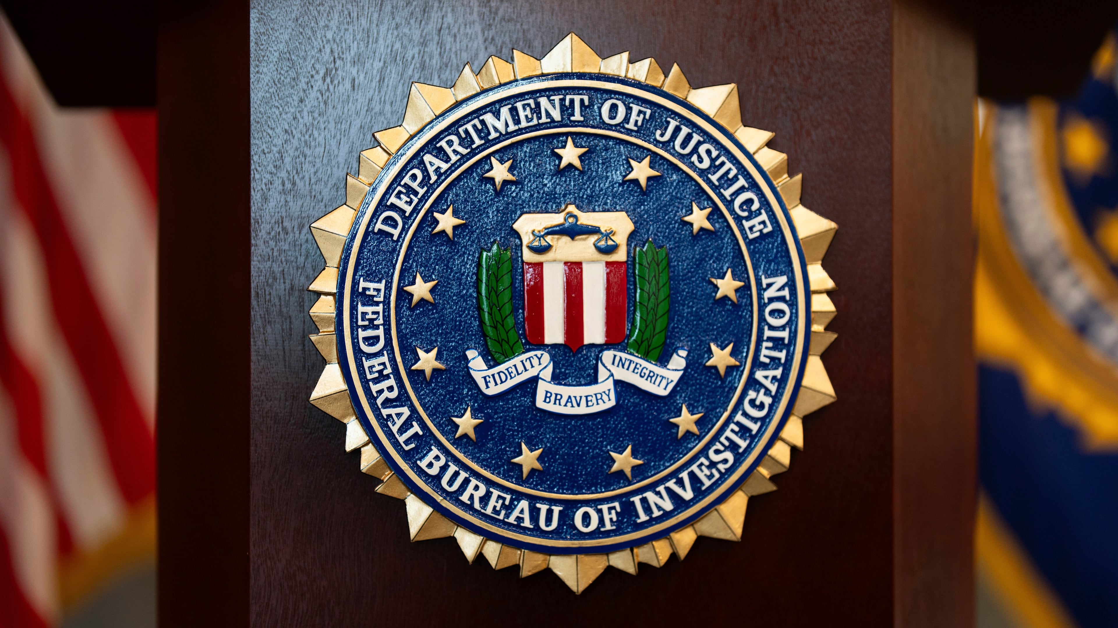 FILE - An FBI seal is displayed on a podium before a news conference at the field office in Portland, Ore., Jan. 16, 2025. (AP Photo/Jenny Kane, File)