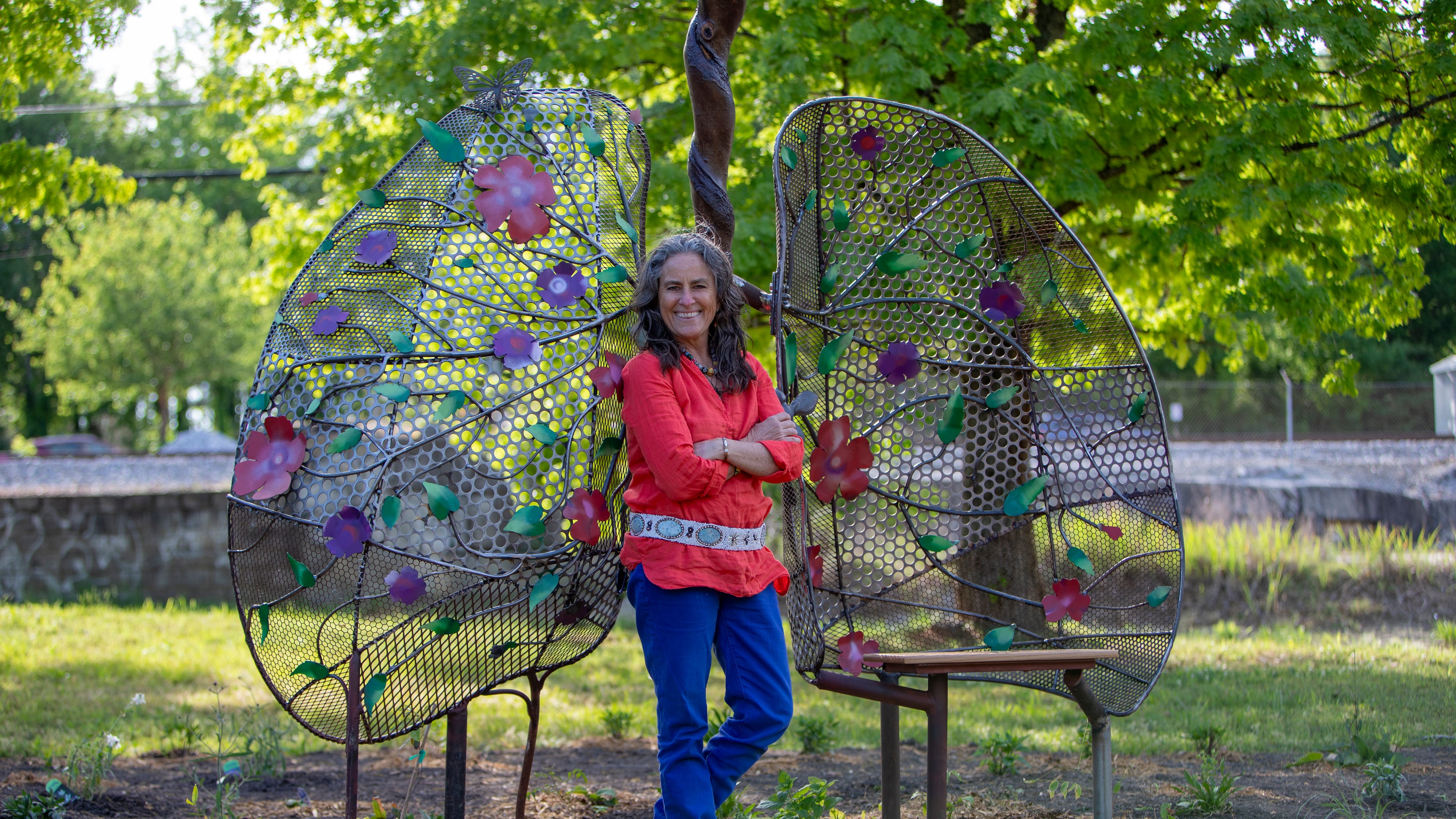 Shannon Willow stands with her sculpture, Lungs of Mother Earth, at a pocket park in Scottdale. The public art is an early element of the Compassion Corridor, a path stretching from Decatur to Stone Mountain. (Courtesy of Isadora Pennington)