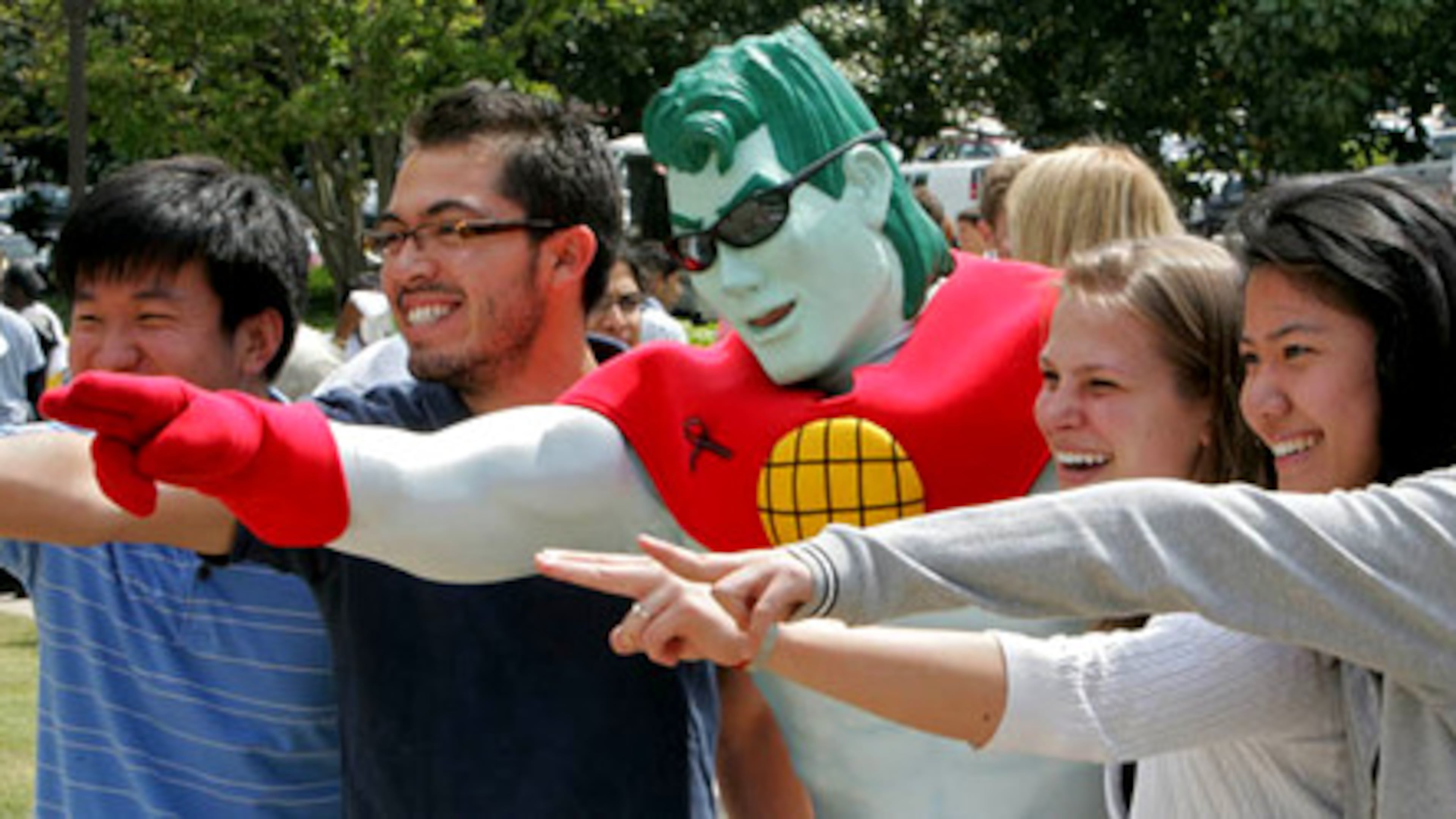 Georgia Tech students (from left) Bob Chen, J.P Aragon, Katy Roege and Lisa Pan pose with their Earth Day hero, Captain Planet (middle) at 10th Annual Georgia Tech Earth Day celebration on April 20, 2007. (John Spink/AJC file)