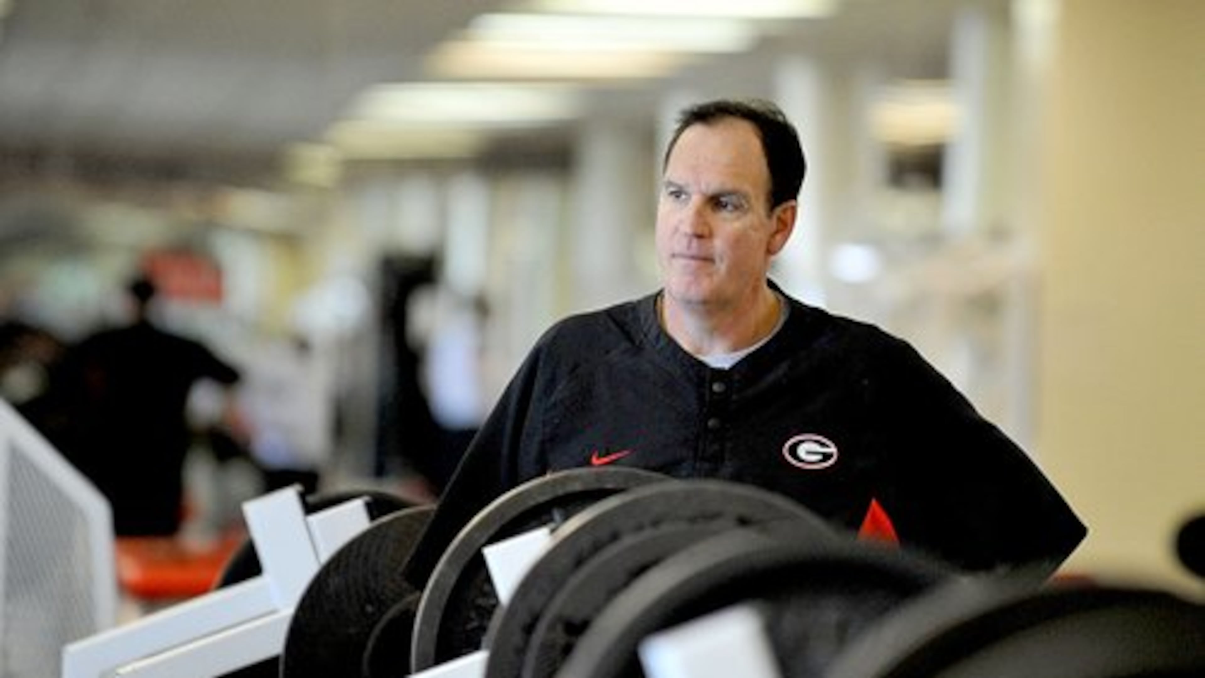 In this 2009 photo, Dave Van Halanger, Georgia's strength and conditioning coach, watches over the players' workouts. Van Halanger has been on Georgia's staff since 2001. He played collegiate football at West Virginia and for the Atlanta Falcons for a season. An injury ended his pro career.