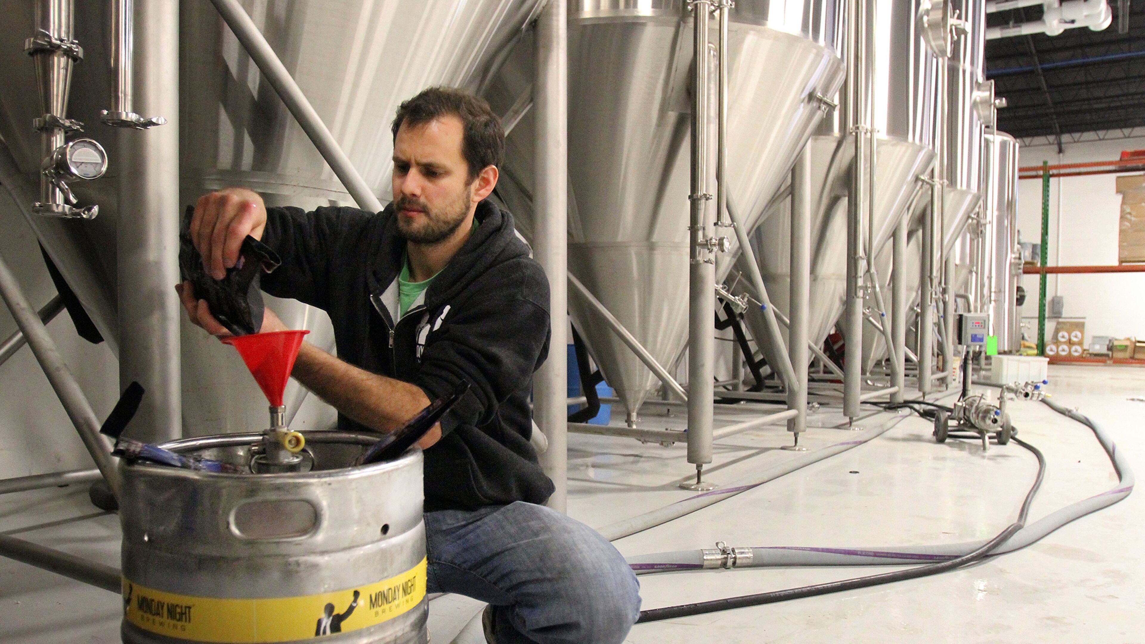 Monday Night Brewing co-owner Joel Iverson tests out different yeasts while helping to produce a batch of Drafty Kilt Scotch Ale at the company’s warehouse in Atlanta. Iverson said a provision in the U.S. Senate GOP’s tax proposal could save his company roughly $60,000 a year. PHIL SKINNER / PSKINNER@AJC.COM