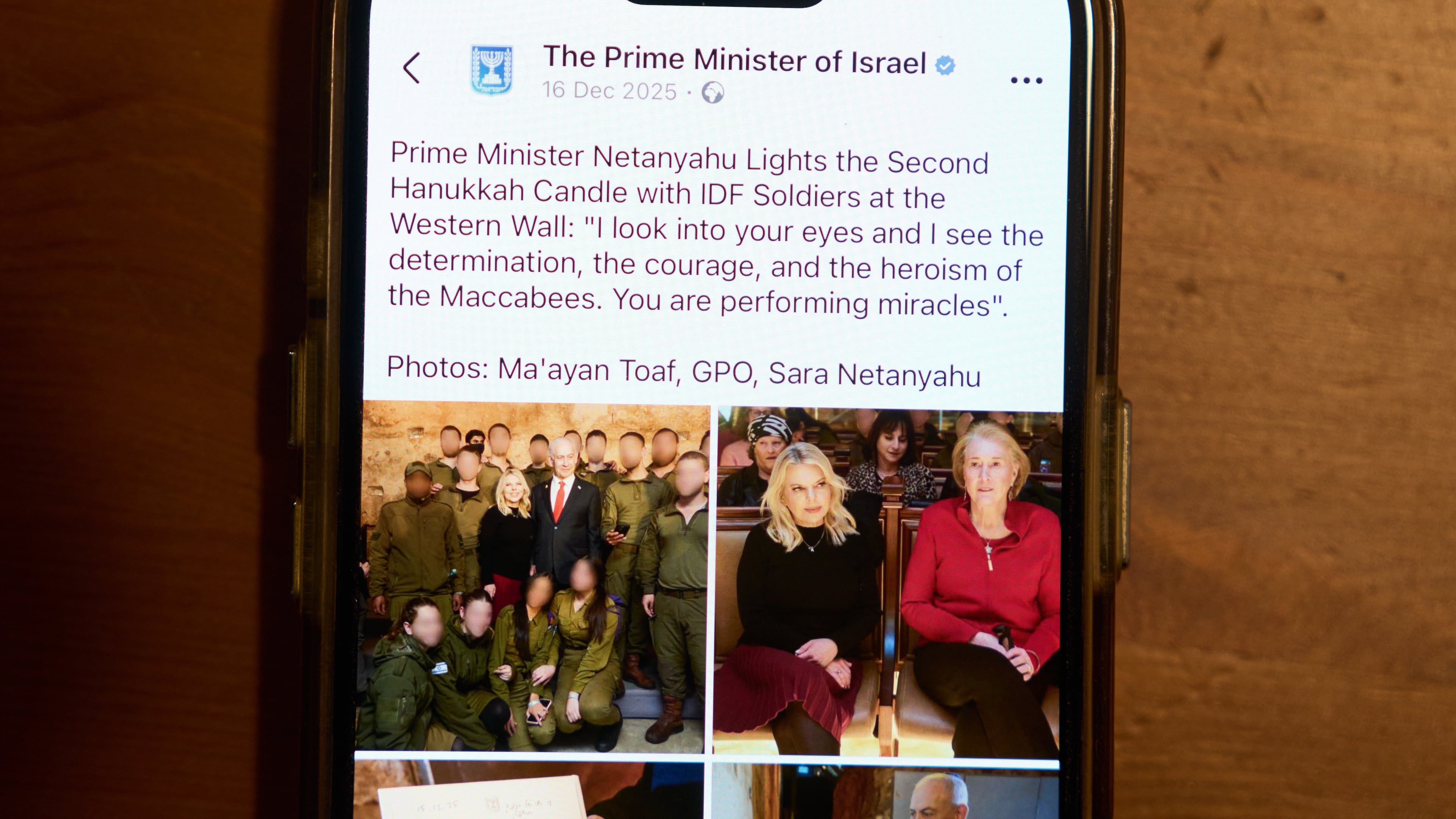 A Facebook post of the Prime Minister of Israel with a retouched photo of the Prime Minister’s wife, Sara Netanyahu, is displayed on a phone in Ramat Gan, Israel, Jan, 9, 2026 (AP Photo/Oded Balilty)
