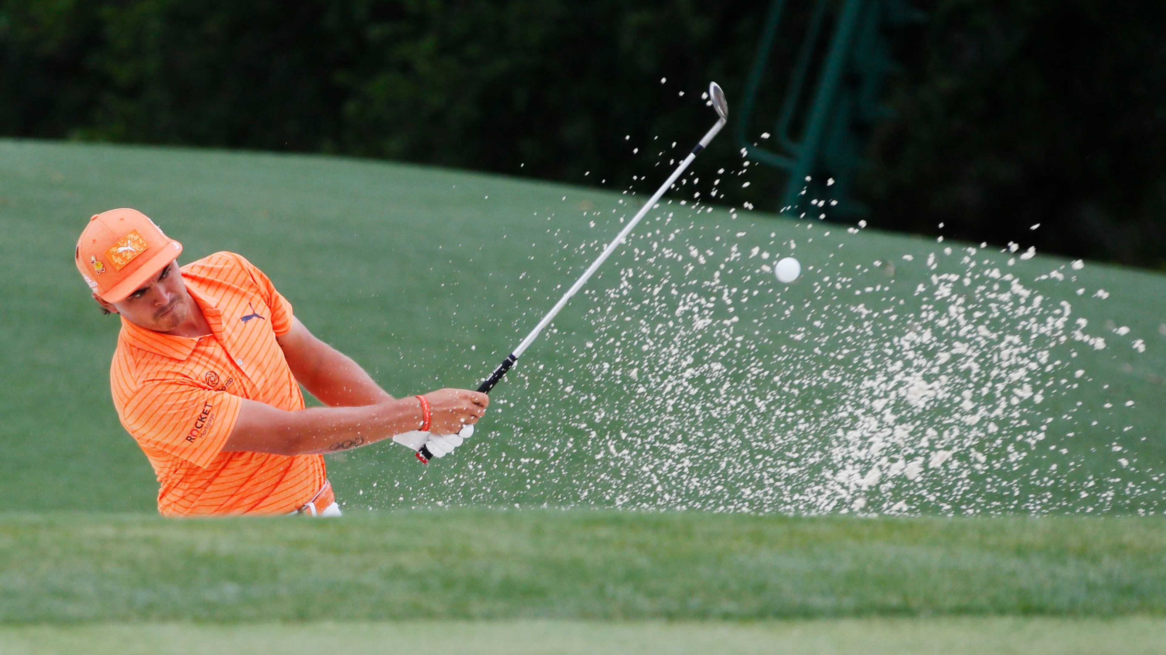 Rickie Fowler hits out of the bunker on 18 during the final round of the Masters Tournament Sunday, April 14, 2019, at Augusta National Golf Club in Augusta.
