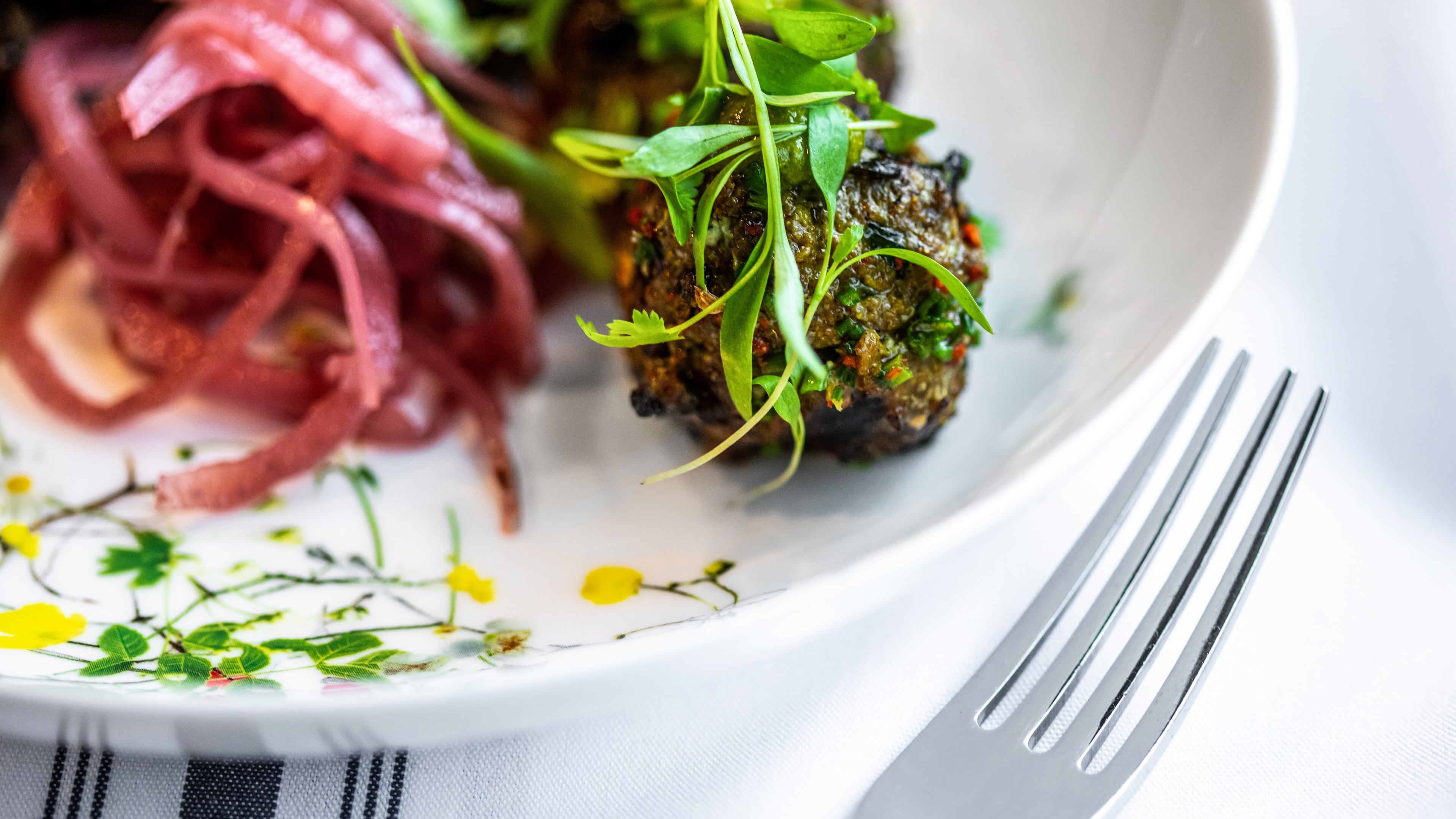 Grilled meatballs with coconut-mint chutney at Fia were inspired by executive chef Burges Jokhi's grandmother and uncle. (Courtesy of Fia Restaurant)