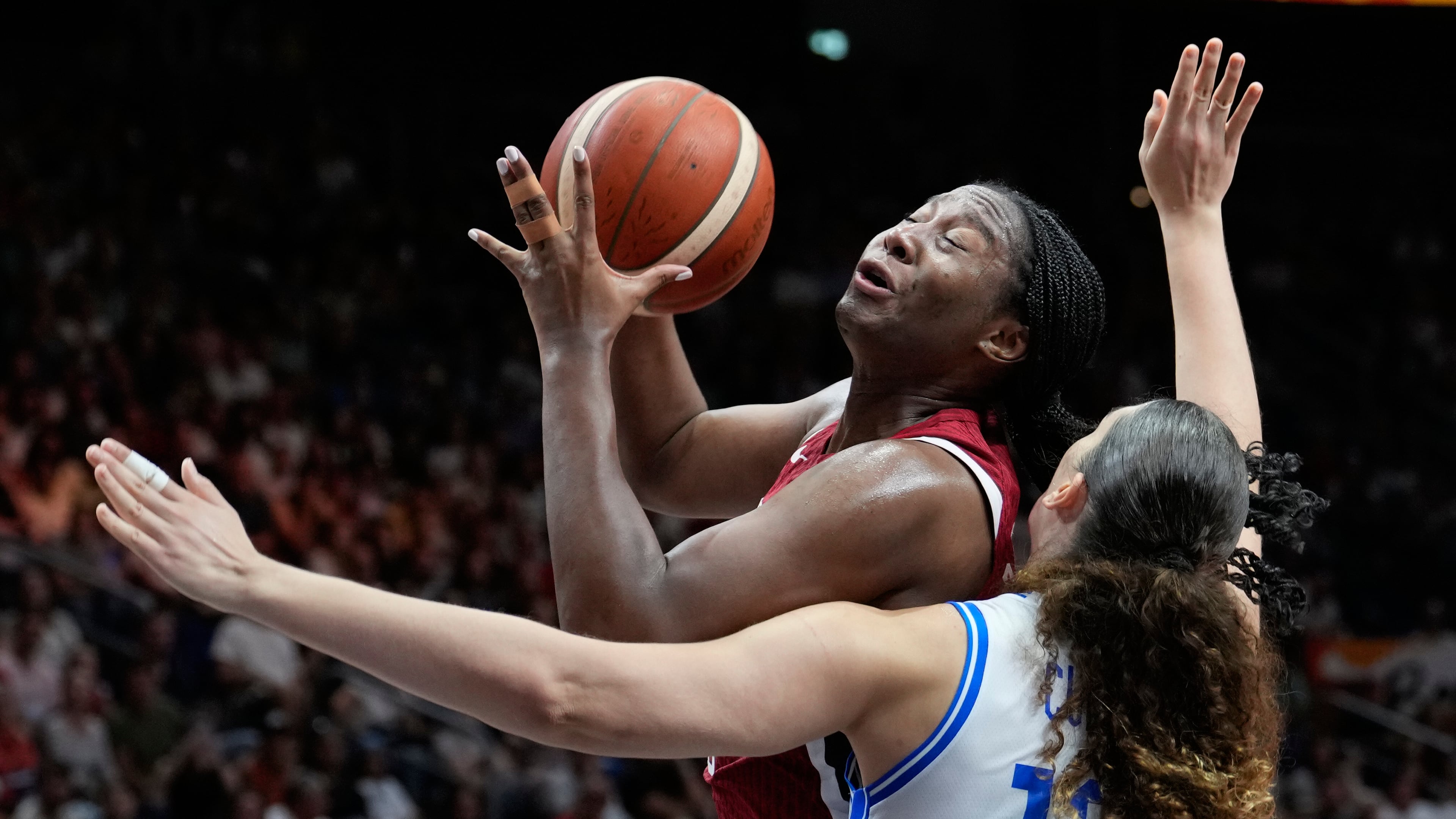 Aliyah Boston, of the United States, shoots over Italy's Lorela Cubaj during the Women's Basketball World Cup match between the United States and Italy in Berlin, Sunday, Sept. 6, 2026. (AP Photo/Ebrahim Noroozi)