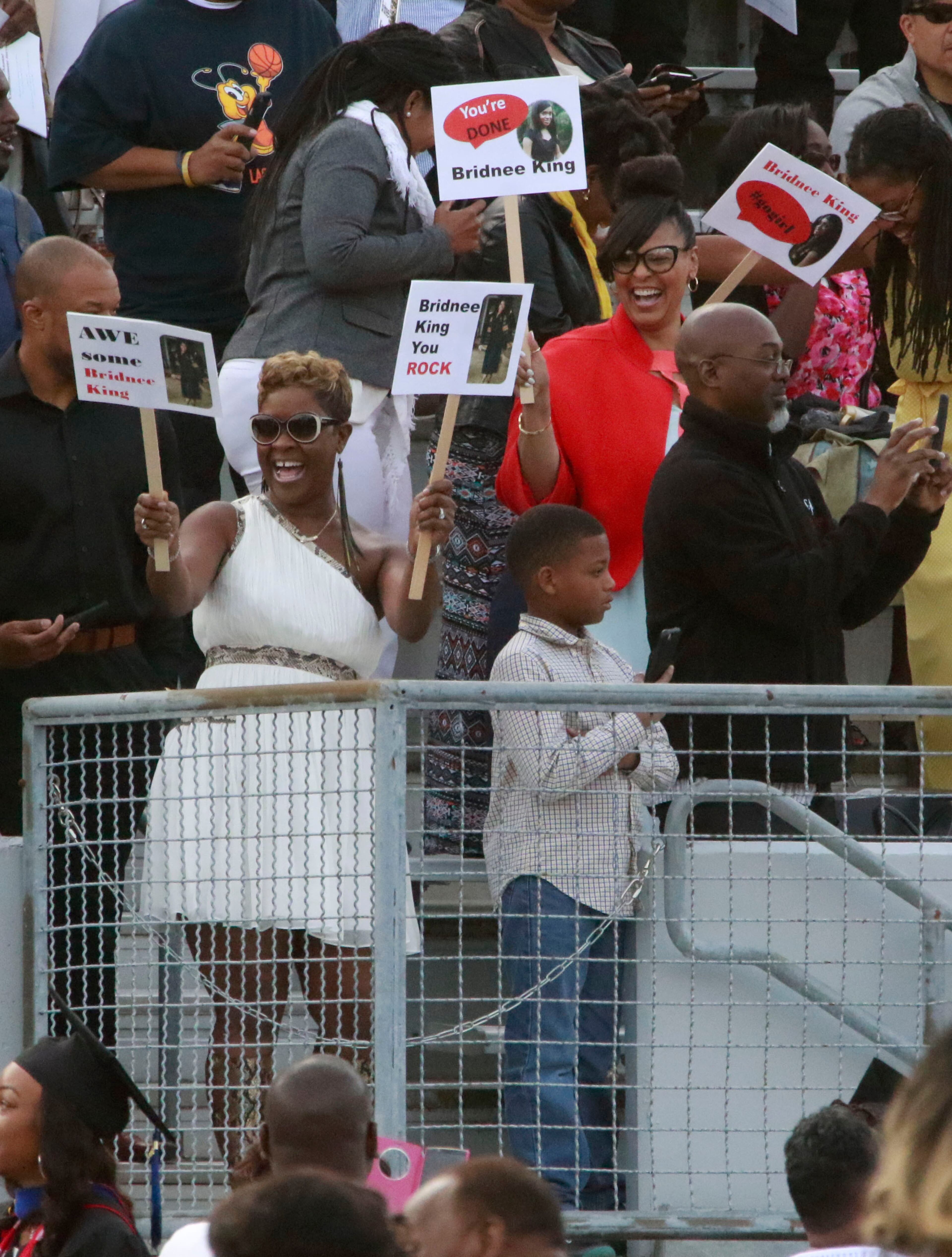 May 16, 2016 - Atlanta - Bridnee King's family cheered her on with signs. Clark Atlanta University class of 2016 filled Panther Stadium Monday morning for it's 27th annual Commencement Service. The keynote speaker was retired astronaut Mae Jemison, the first woman of color in Space. Honorary degrees were awarded to Hamilton Bohannon, a 1964 graduate of Clark College; Roland Carter; Congressman John Conyers, and Congressman Hank Johnson, a 1976 Clark College graduate. BOB ANDRES / BANDRES@AJC.COM