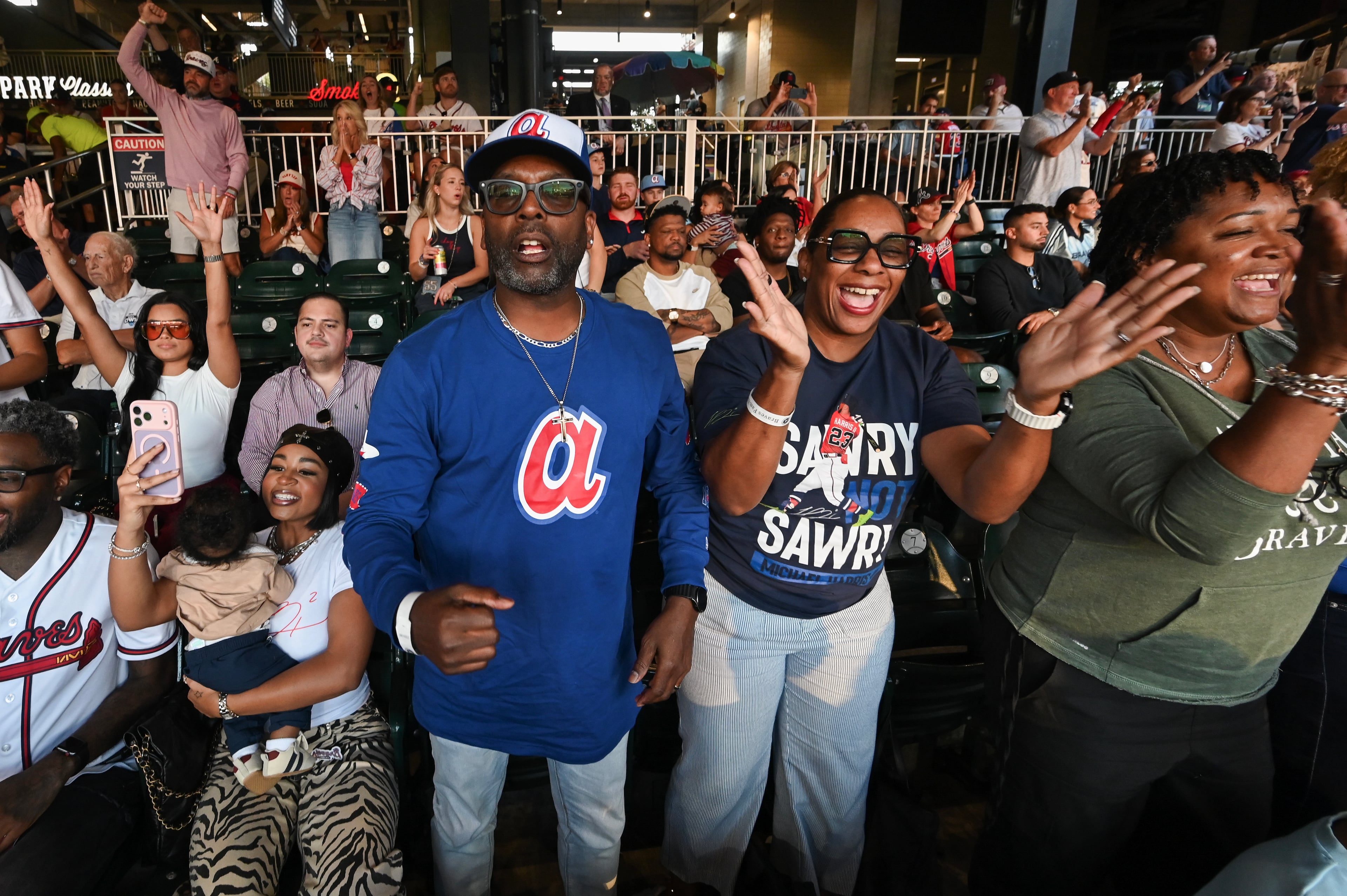 Michael and LaTaucha Harris watch their son Atlanta Braves center fielder Michael Harris II single on a bunt during the second inning of Game 3 of the MLB National League Division Series between the Atlanta Braves and the Los Angeles Dodgers, Tuesday, Oct. 6, 2026, in Atlanta. (Hyosub Shin/AJC)