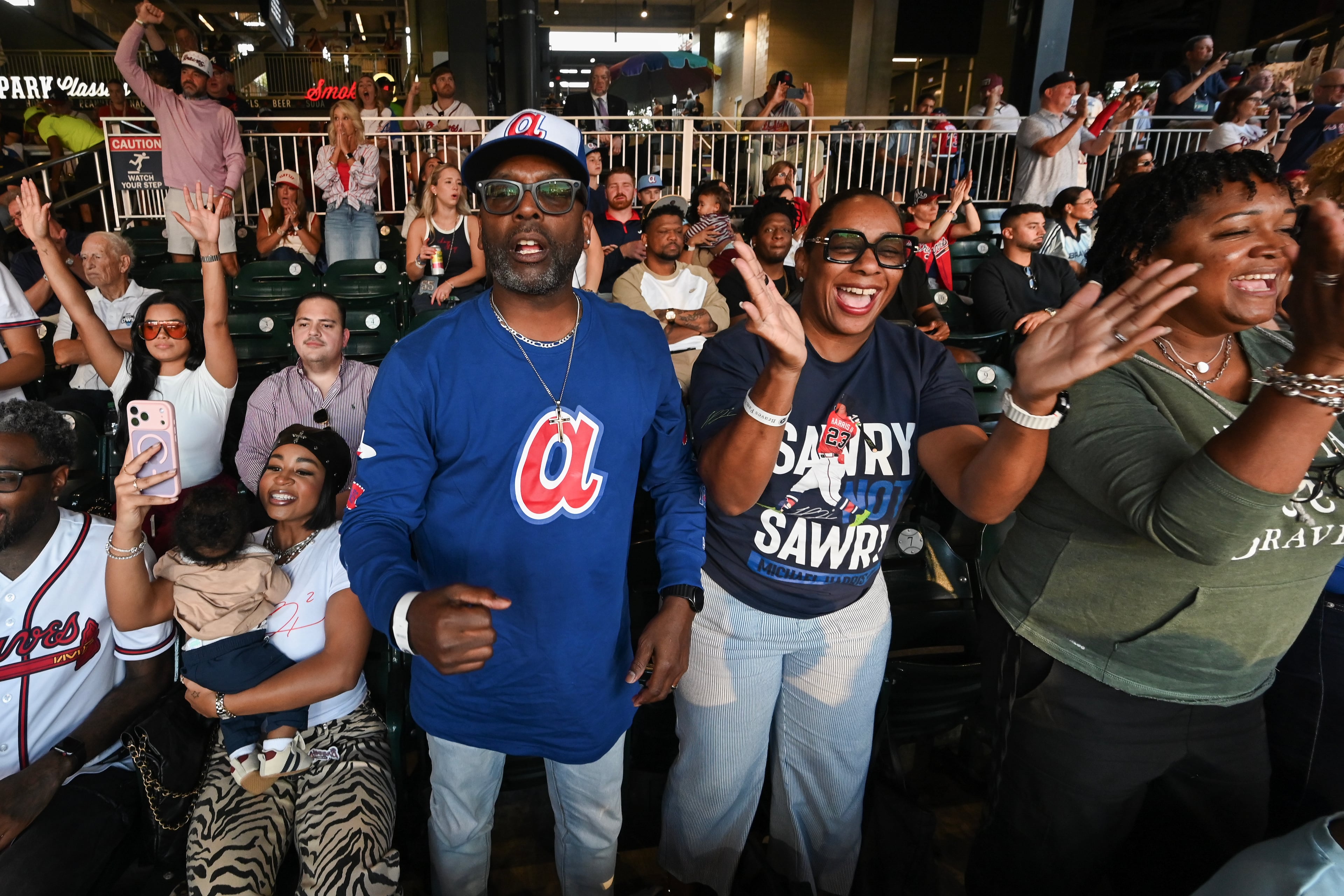 Michael and LaTaucha Harris watch their son, Braves center fielder Michael Harris II, single on a bunt against the Dodgers during Game 3 of their National League Division Series on Tuesday, Oct. 6, 2026, in Atlanta. (Hyosub Shin/AJC)