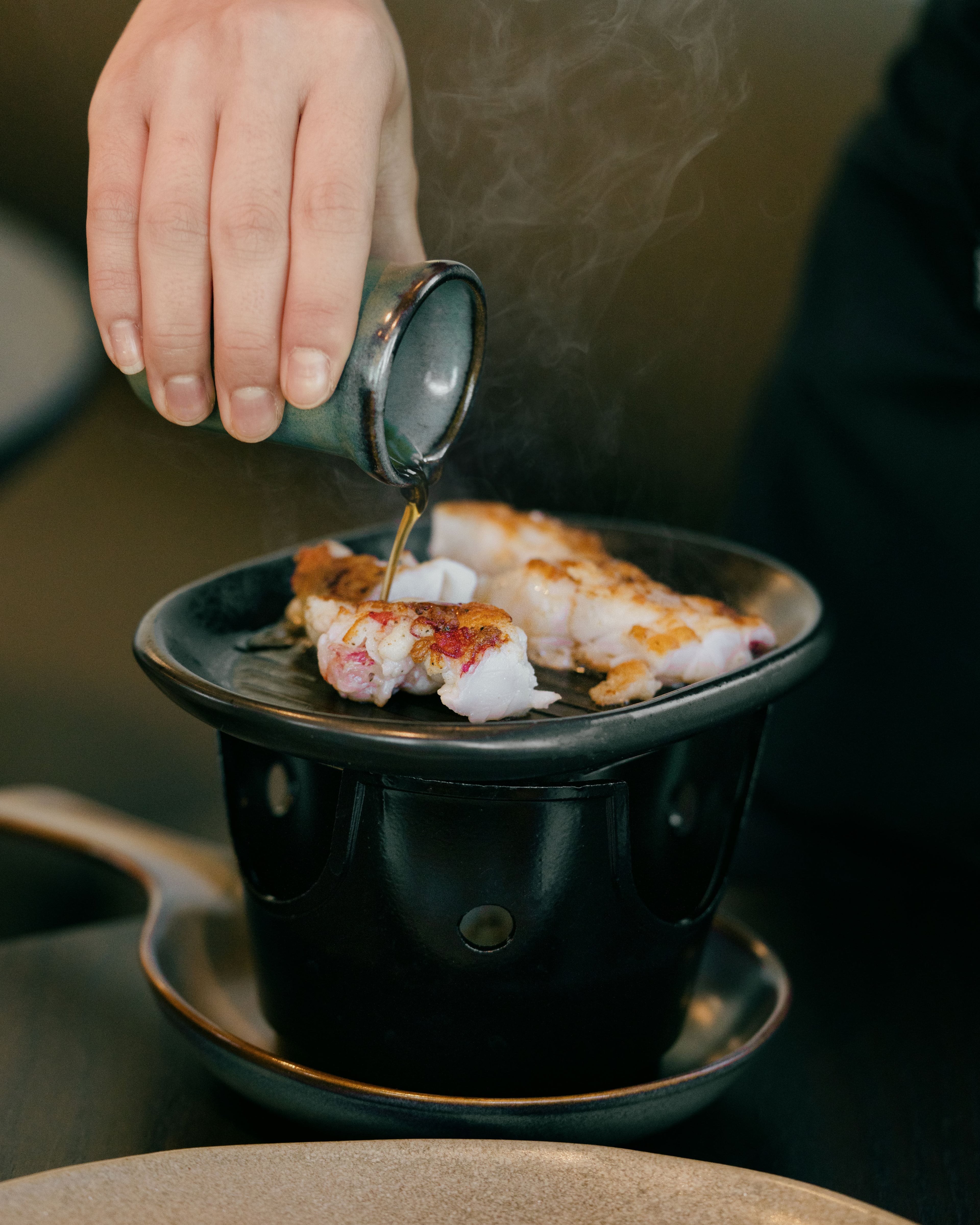 Celestia's lobster toban yaki, grilled at the table in soy brown butter, is a showy dish befitting the restaurant's setting. (Adrian Profumo, courtesy of Celestia)