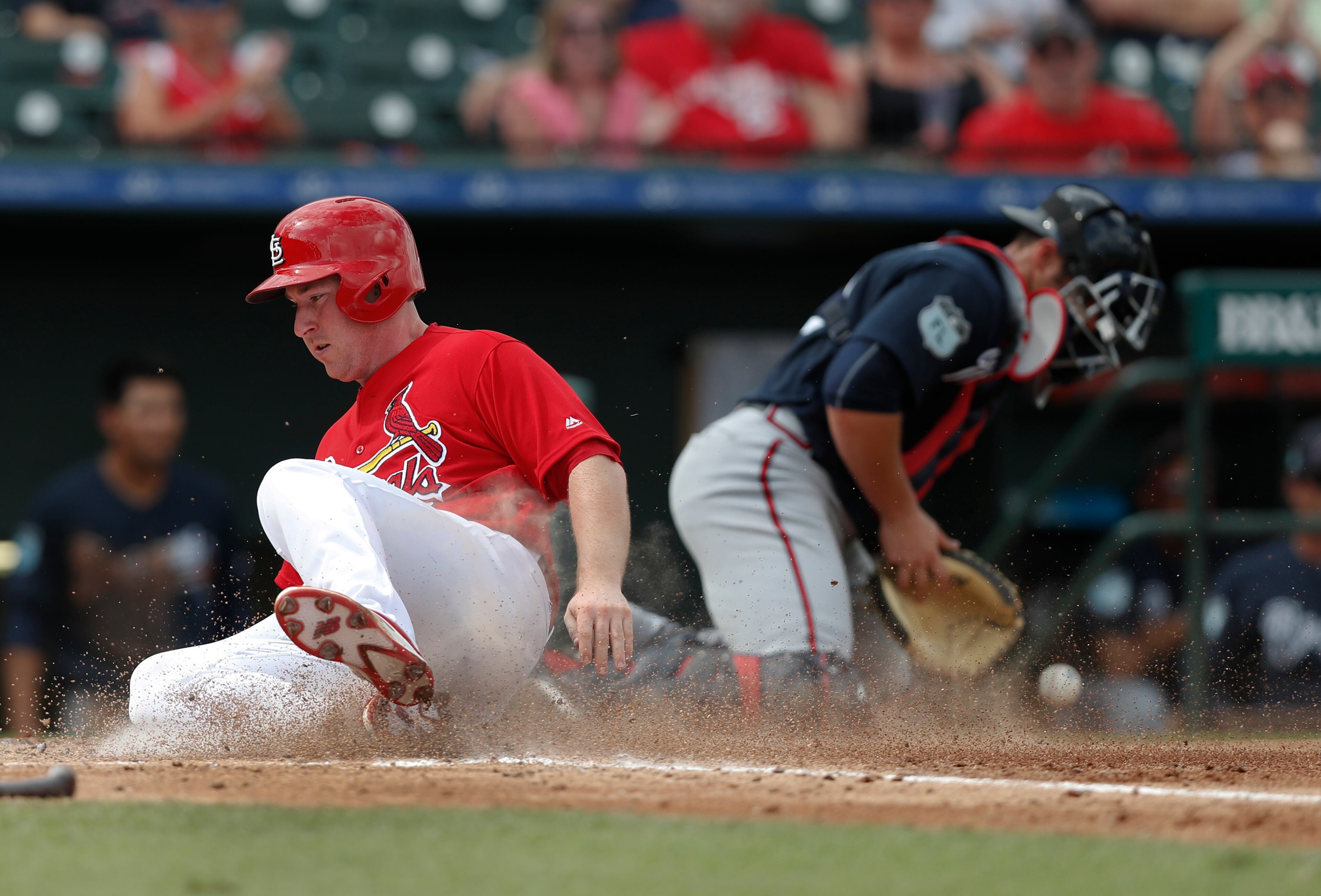 St. Louis Cardinals' Jedd Gyorko (3) scores on a hit by Carson Kelly as Atlanta Braves catcher Anthony Recker (20) handles the late throw in the fourth inning of a spring training baseball game Thursday, March 2, 2017, in Jupiter, Fla. (AP Photo/John Bazemore)