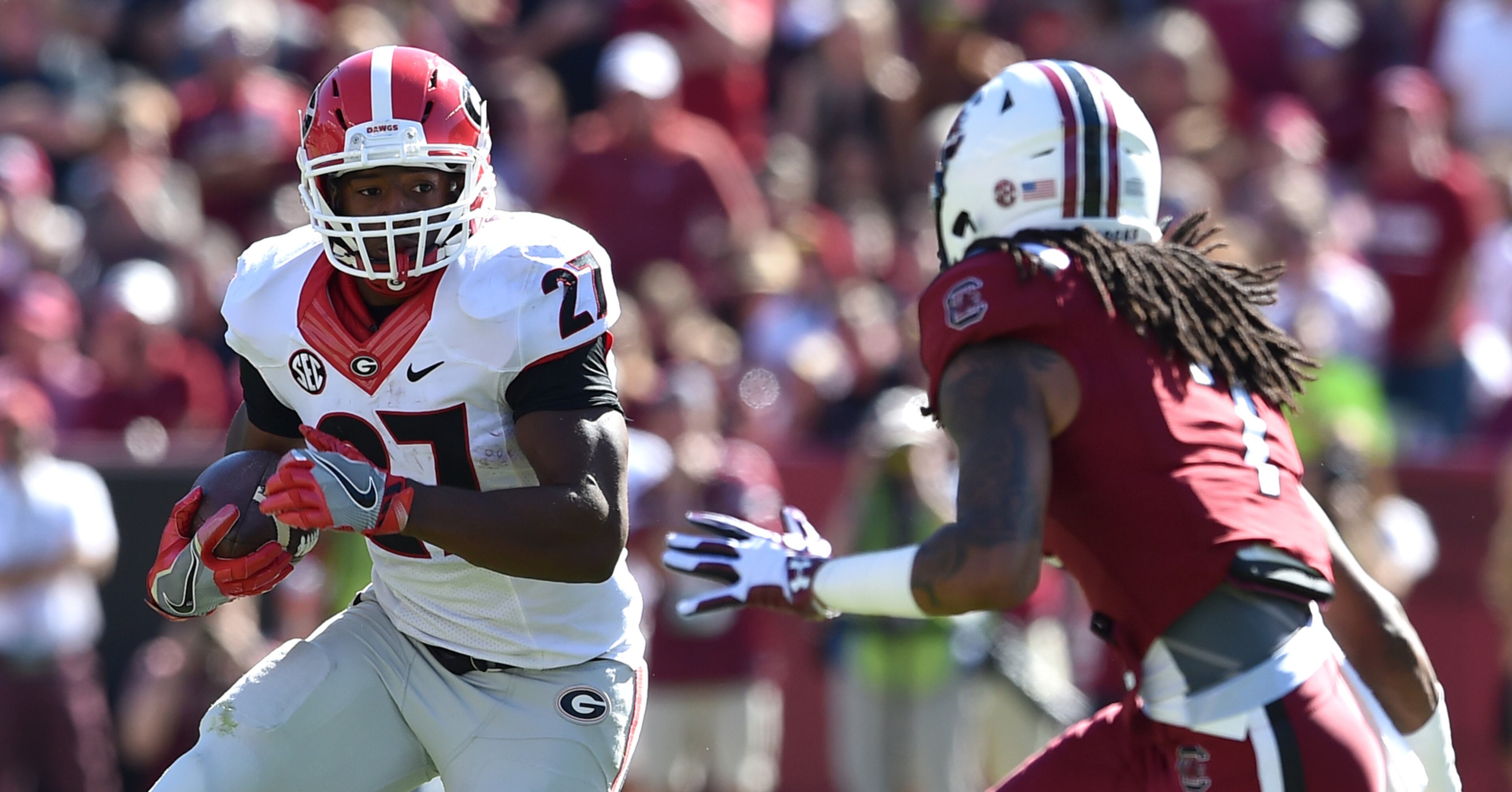 October 9, 2016 Columbia, SC: Georgia Bulldogs running back Nick Chubb looks for running room around South Carolina Gamecocks defensive back Jamarcus King Sunday October 9, 2016 at Williams- Brice Stadium in Columbia, SC. The game was delayed one day due to hurricane Matthew which hit the East Coast, including much of South Carolina BRANT SANDERLIN/BSANDERLIN@AJC.COM