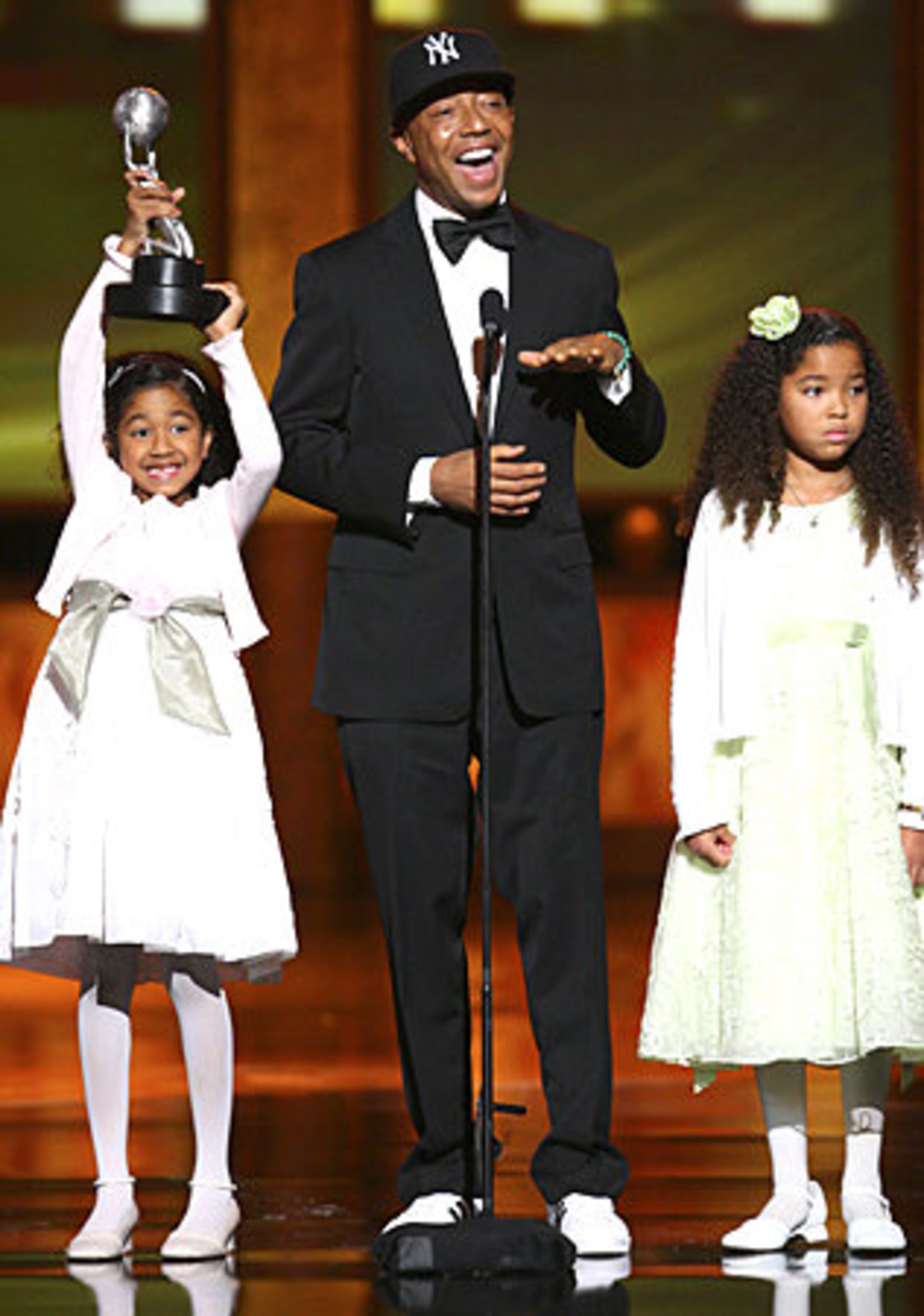 Producer Russell Simmons (C) and daughters accept the Vanguard Award.