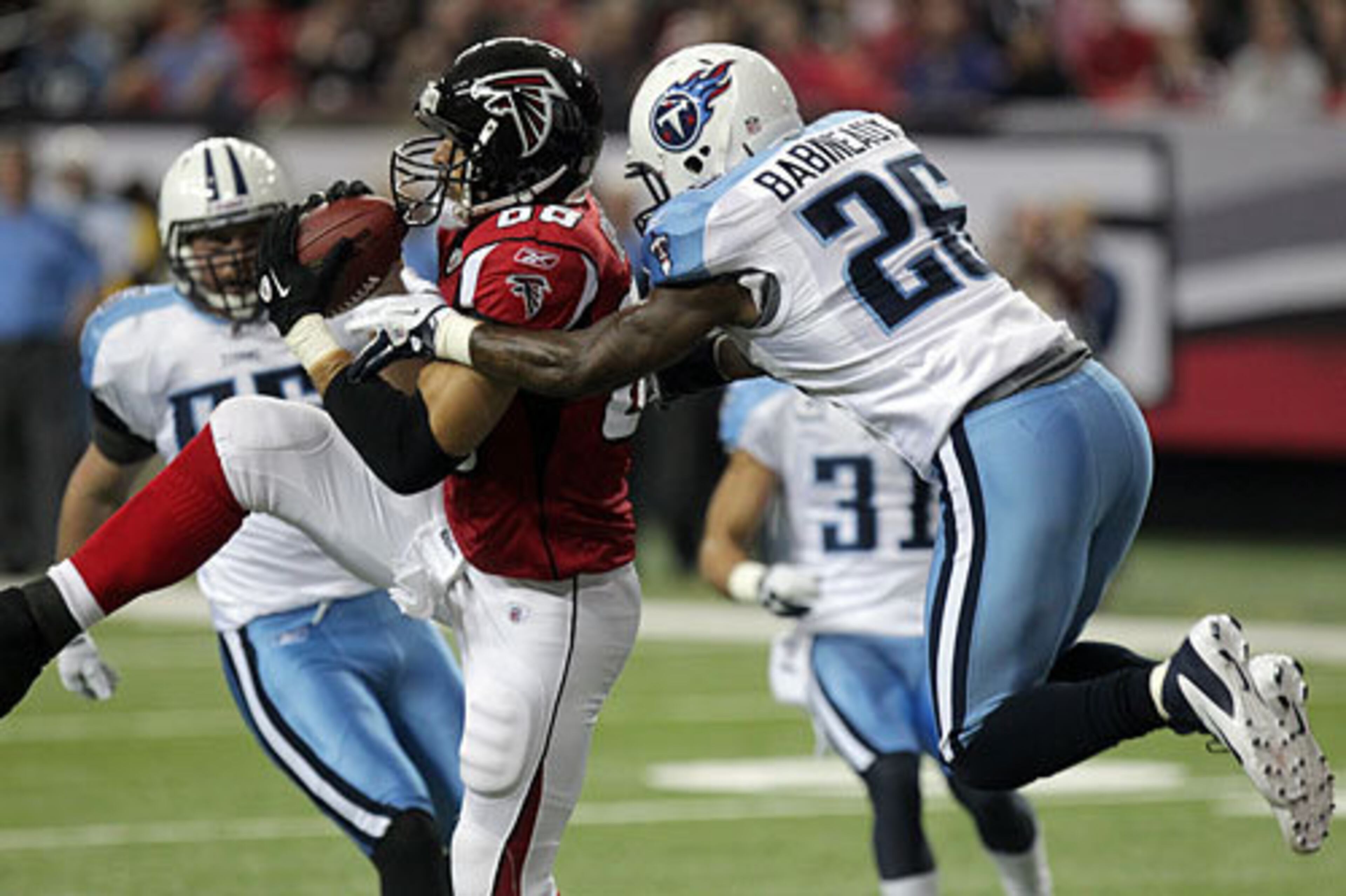 Atlanta Falcons tight end Tony Gonzalez catches a touchdown pass in front of Tennessee Titans safety Jordan Babineaux for a 7-0 Falcons lead with the PAT during 1st quarter action at the Georgia Dome in Atlanta on Sunday, Nov. 20, 2011.