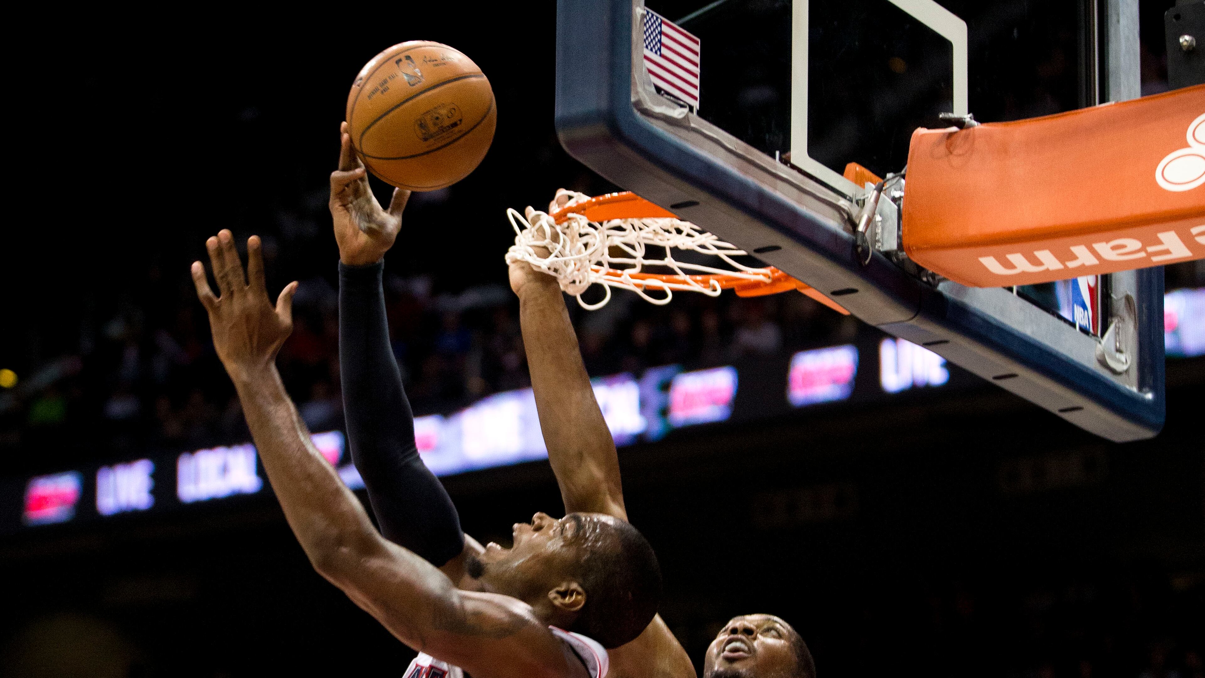 Atlanta Hawks forward Paul Millsap (4) vies with Utah Jazz forward Derrick Favors (15) for a rebound during the first half of an NBA basketball game Wednesday, Nov. 12, 2014, in Atlanta. (AP Photo/John Bazemore)