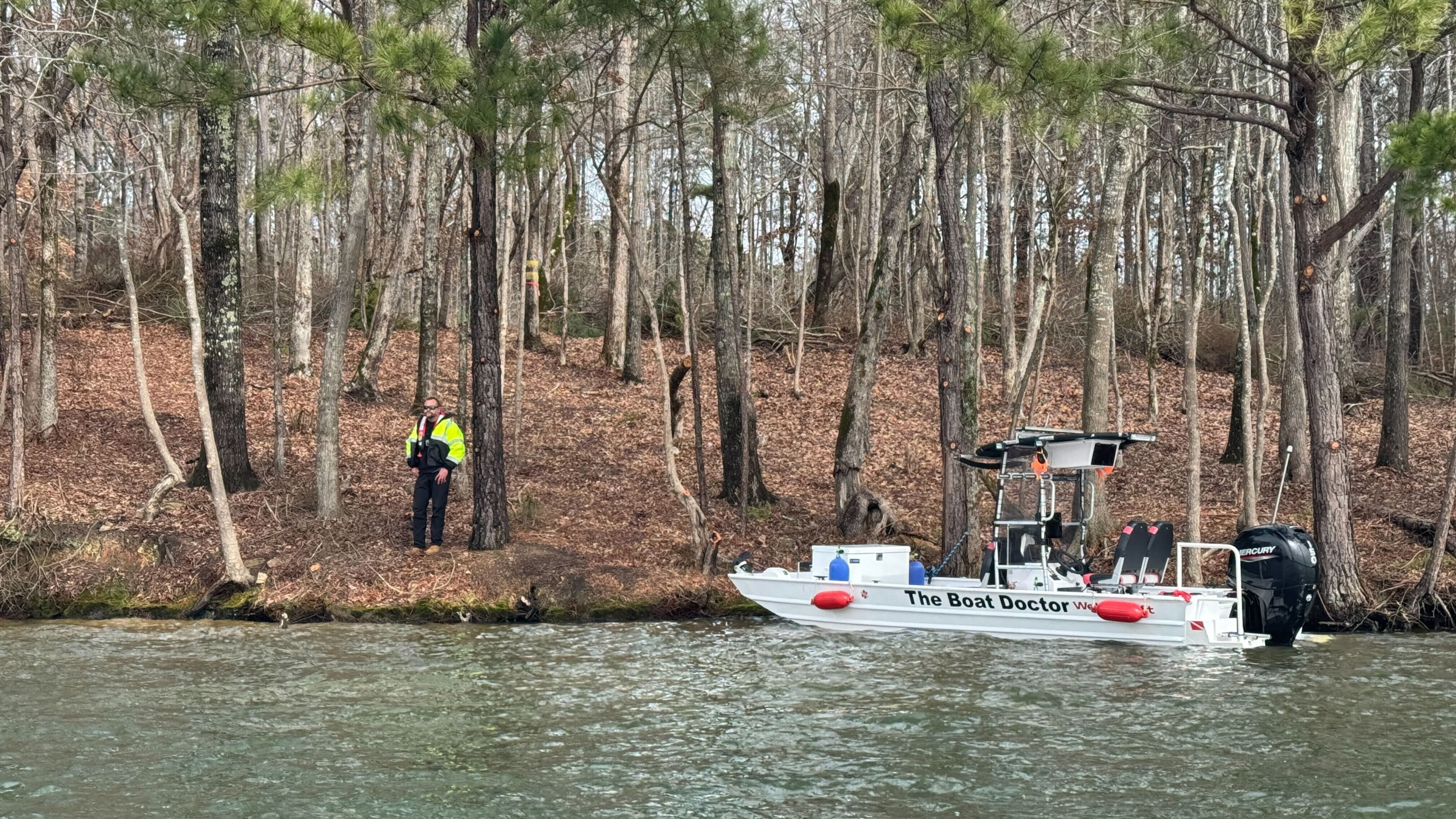A DNR agent stands on the bank of Lake Oconee where shoes were found that are believed to belong to Gary Jones.