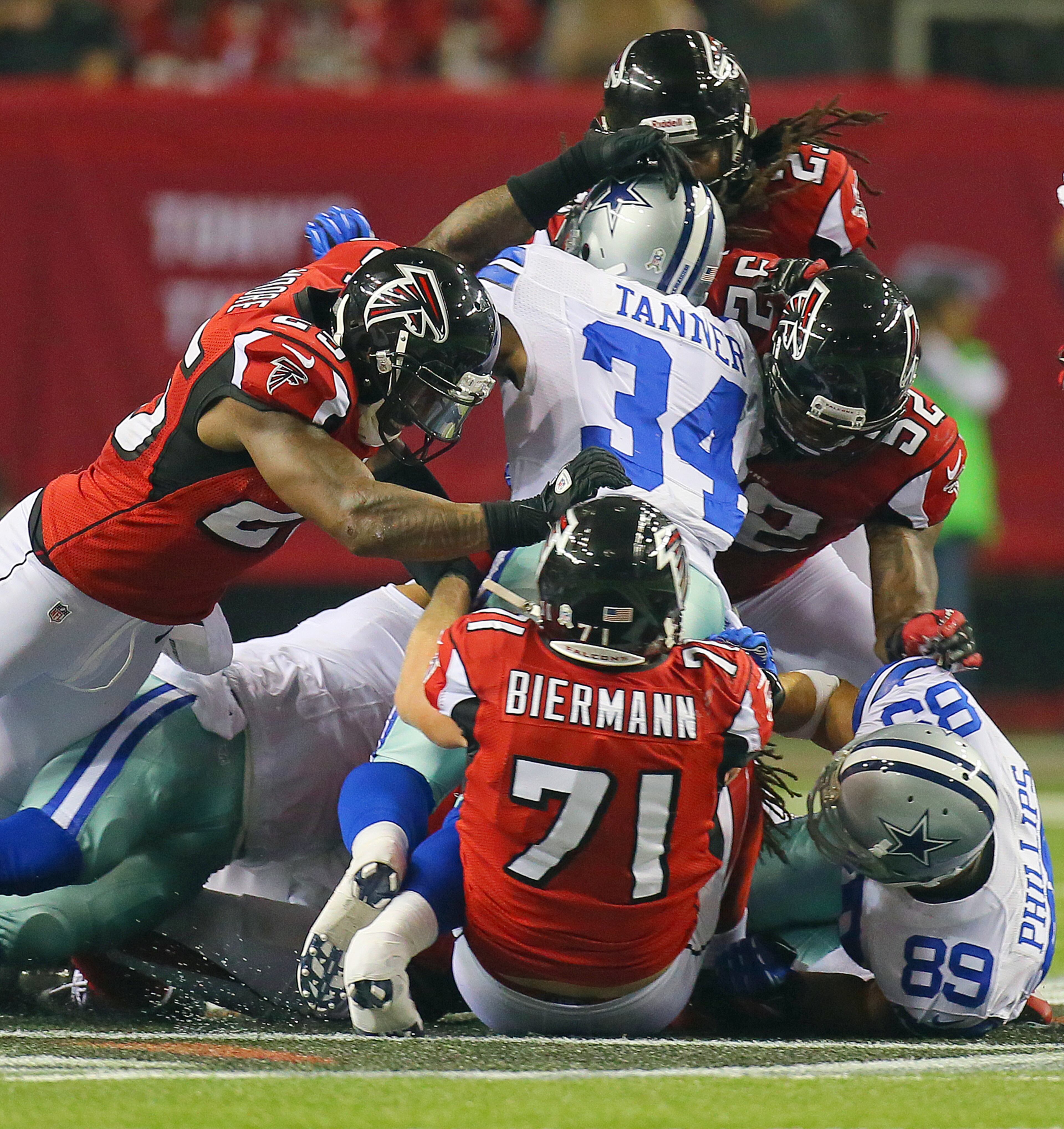 The Atlanta Falcons defenses makes a big stop on Cowboys running back Phillip Tanner on third down forcing Dallas to punt on fourth down in the final minutes of the first half at the Georgia Dome in Atlanta on Sunday, Nov. 4, 2012. The Falcons drove for a field goal after the play to tie the game 6-6 at the half. CURTIS COMPTON / CCOMPTON@AJC.COM