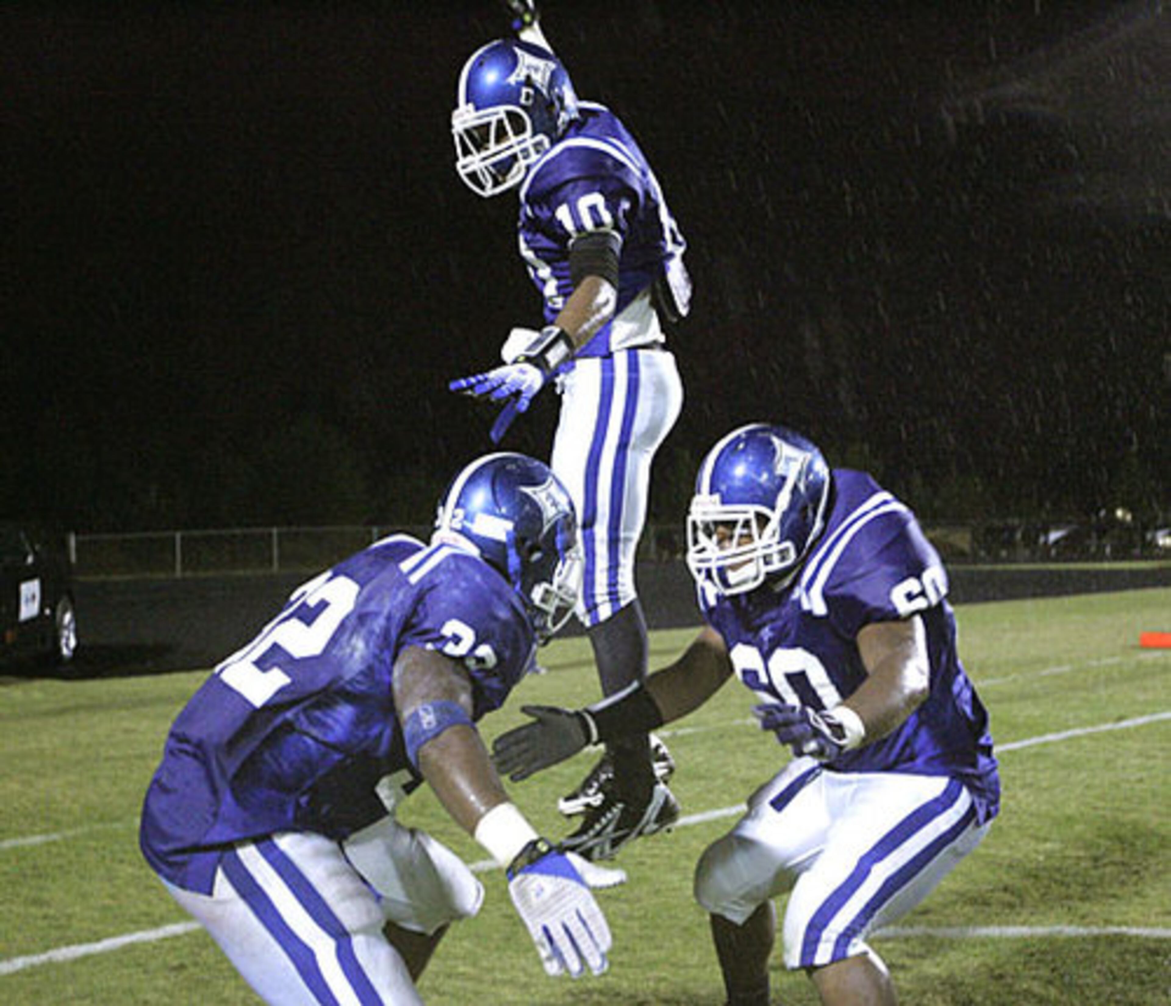 Peachtree Ridge WR Brad Roby (10) Ronnie Smith, left, and Corey Brabham, right, celebrate Roby's touchdown against North Gwinnett.