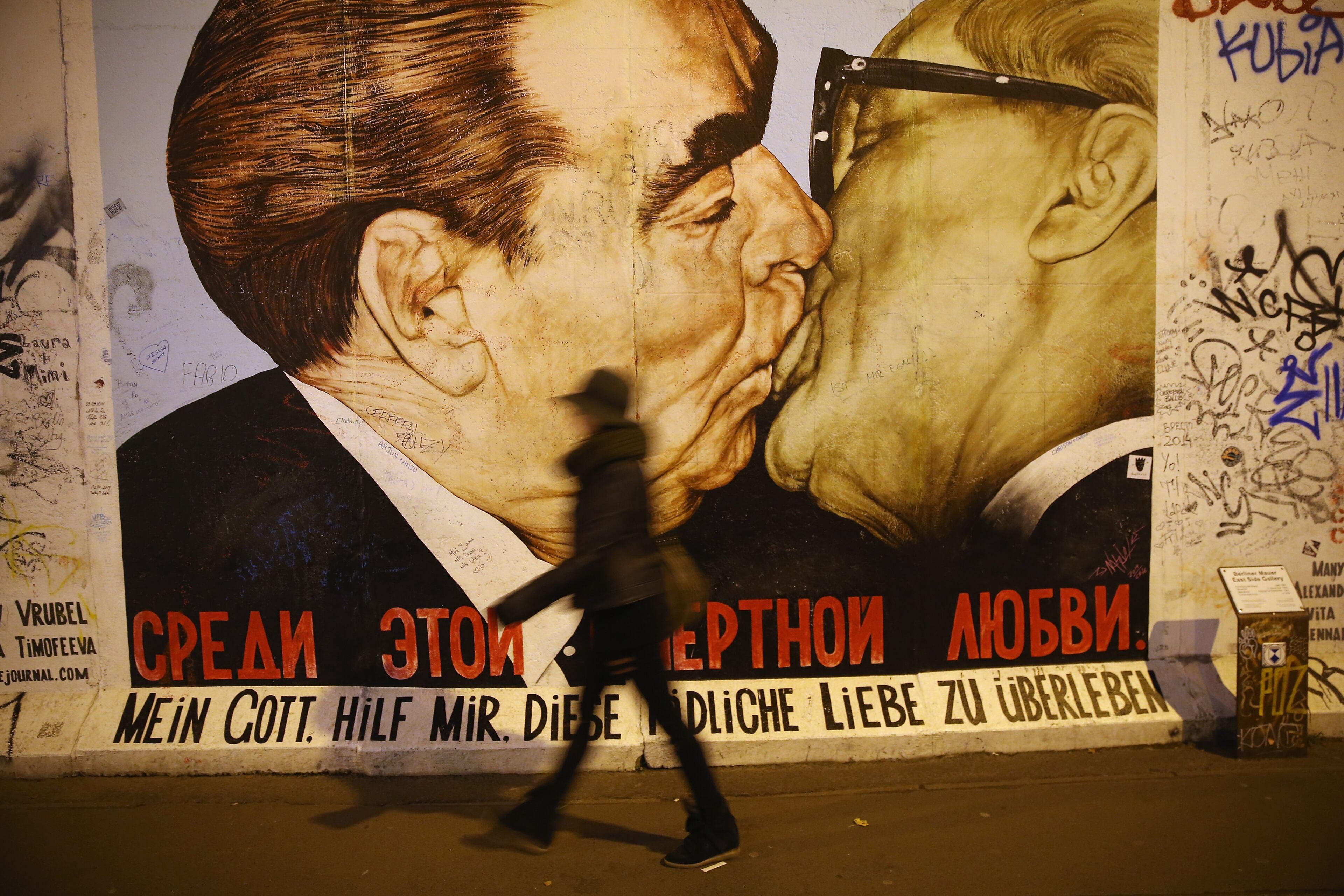 It was the kiss seen round the world -- Soviet leader Leonid Brezhnev and East German communist leader Erich Honecker shared a kiss in 1979 to comemorate the 30th anniversary of the German Democratic Republic. Russian painter Dmitri Vrubel later painted the kiss on a 1.3 km-long original section of the Berlin Wall which became a tourist attraction and was captioned with, "God help me survive this deadly love affair." (Photo by Sean Gallup/Getty Images)
