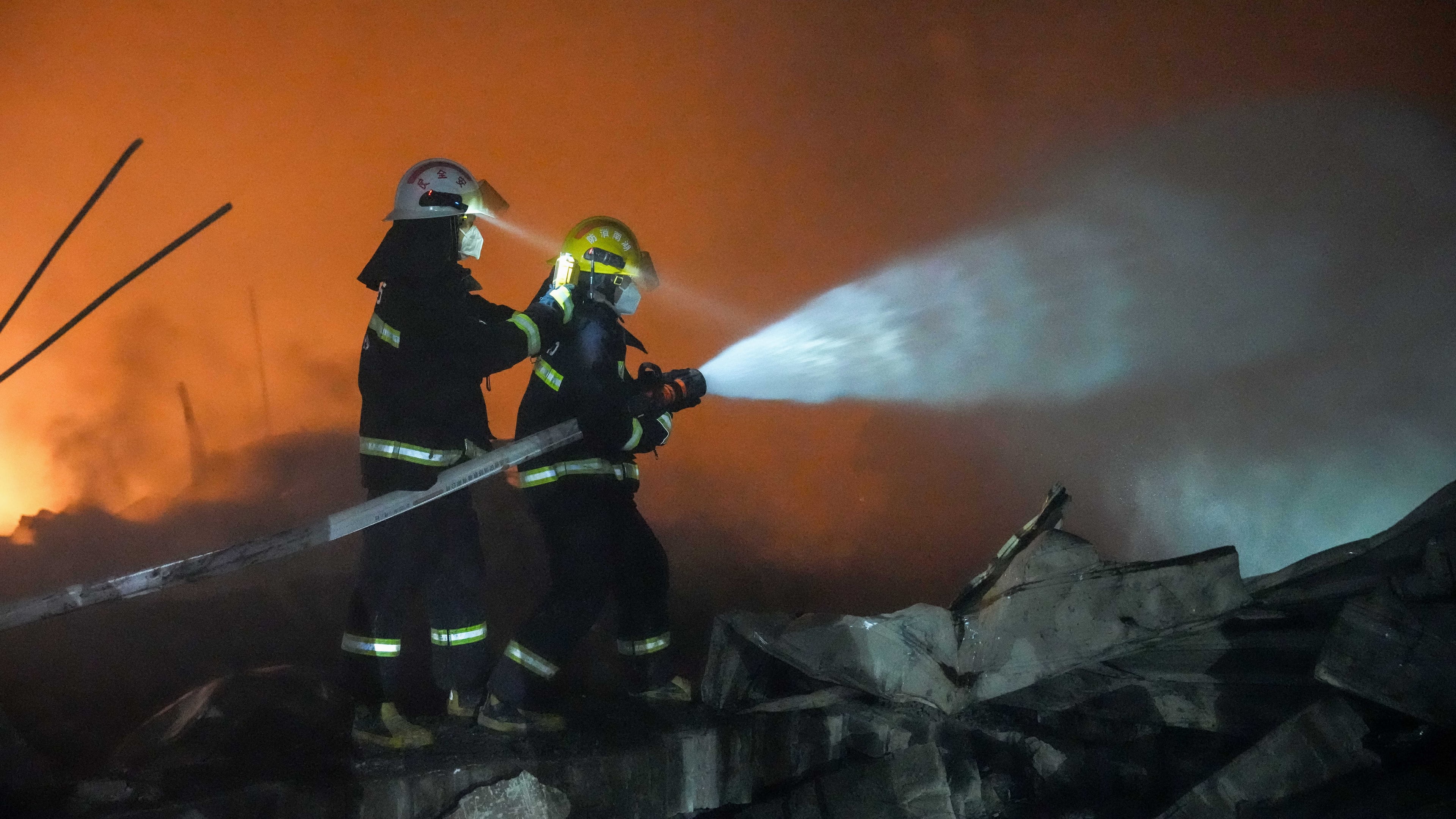 In this photo released by Xinhua News Agency, firefighters work to out the fire after an explosion at a fireworks plant in Guandu Town of Liuyang, central China's Hunan Province, in the early hours of May 5, 2026. (Chen Sihan/Xinhua via AP)