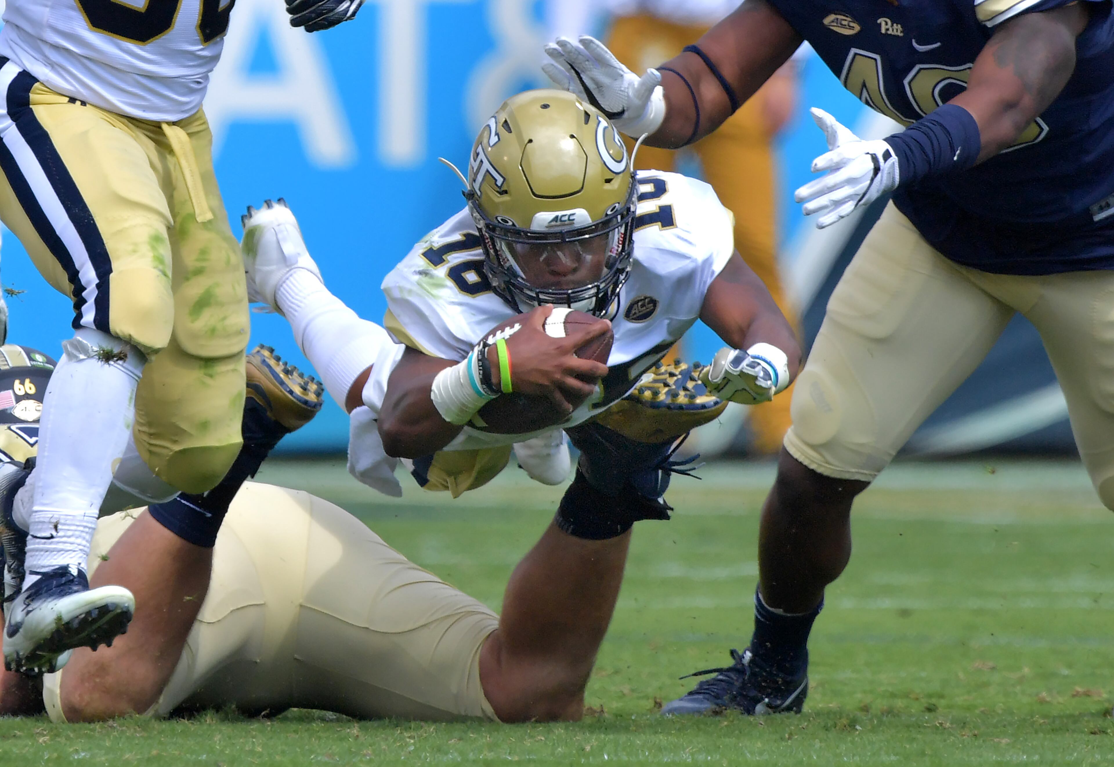 September 23, 2017 Atlanta - Georgia Tech quarterback TaQuon Marshall (16) leaps over Pittsburgh defensive lineman Mike Herndon (66) for yardage in the first half of an NCAA college football game at Bobby Dodd Stadium on Saturday, September 23, 2017. Georgia Tech won 35 - 17 over the Pittsburgh. HYOSUB SHIN / HSHIN@AJC.COM