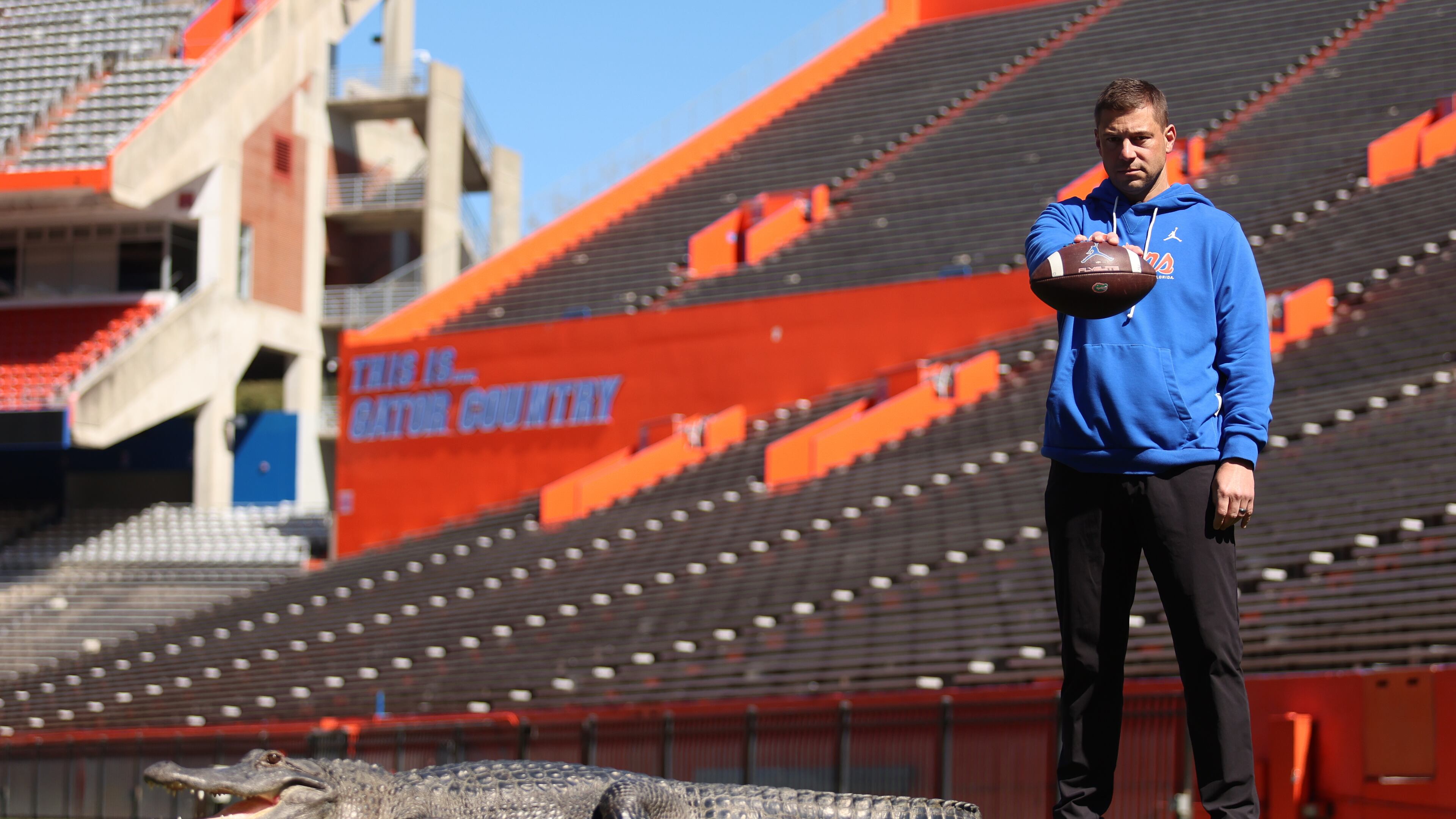 This photo provided by the University of Florida shows Florida football head coach Jon Sumrall posing with an alligator named Helene inside Ben Hill Griffin Stadium, Tuesday, Feb. 24, 2026, in Gainesville, Fla. (Jordan Perez/University of Florida via AP)