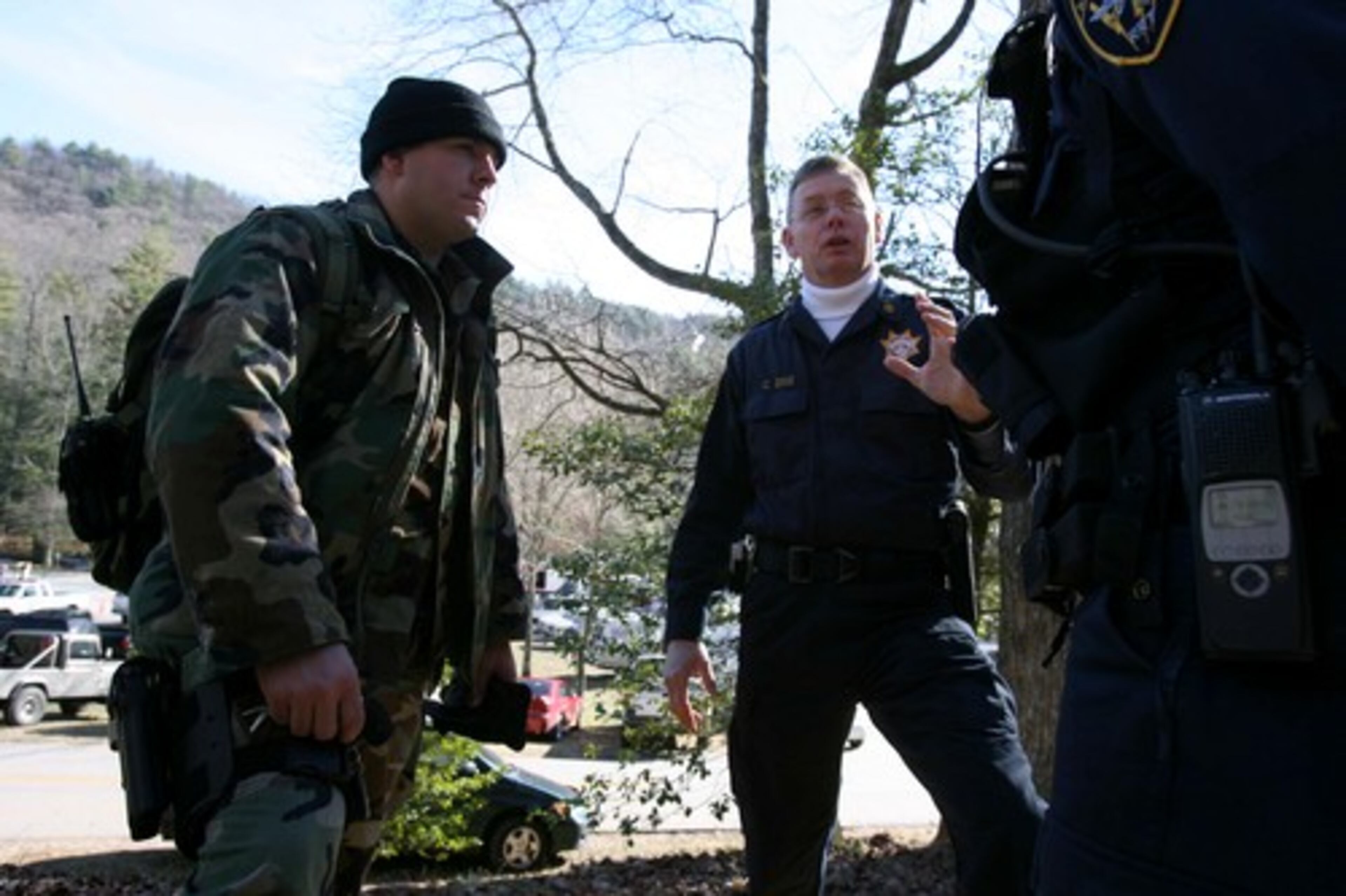 Major Carl Sims of Gwinnett County Sheriff's Department briefs his Rapid Response Team at Vogel State Park Friday. Tom Jewell (left) is with the team.