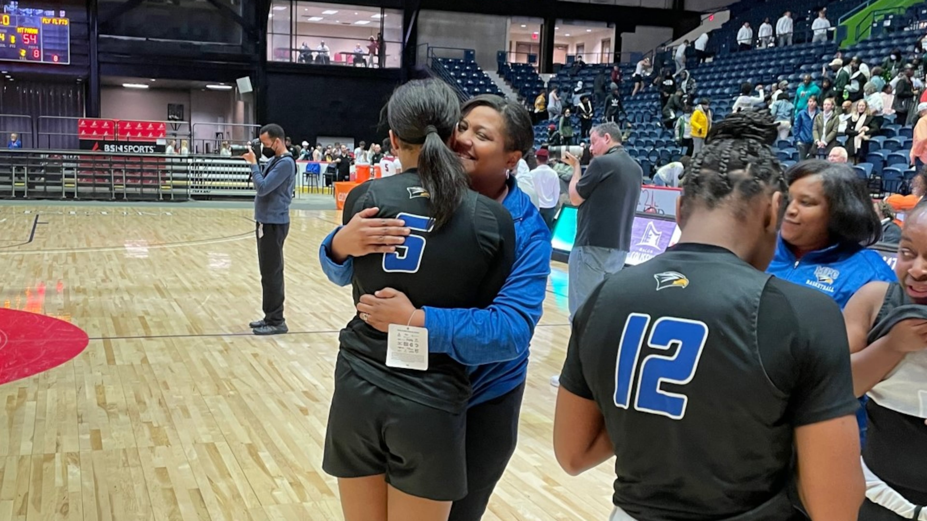 Mount Paran's Kara Dunn (5) celebrates with her mother and coach, Stephanie Dunn, after the Eagles' 54-49 victory over Hebron Christian is the Class A Private girls basketball championship game on March 12, 2022, at the Macon Coliseum.
