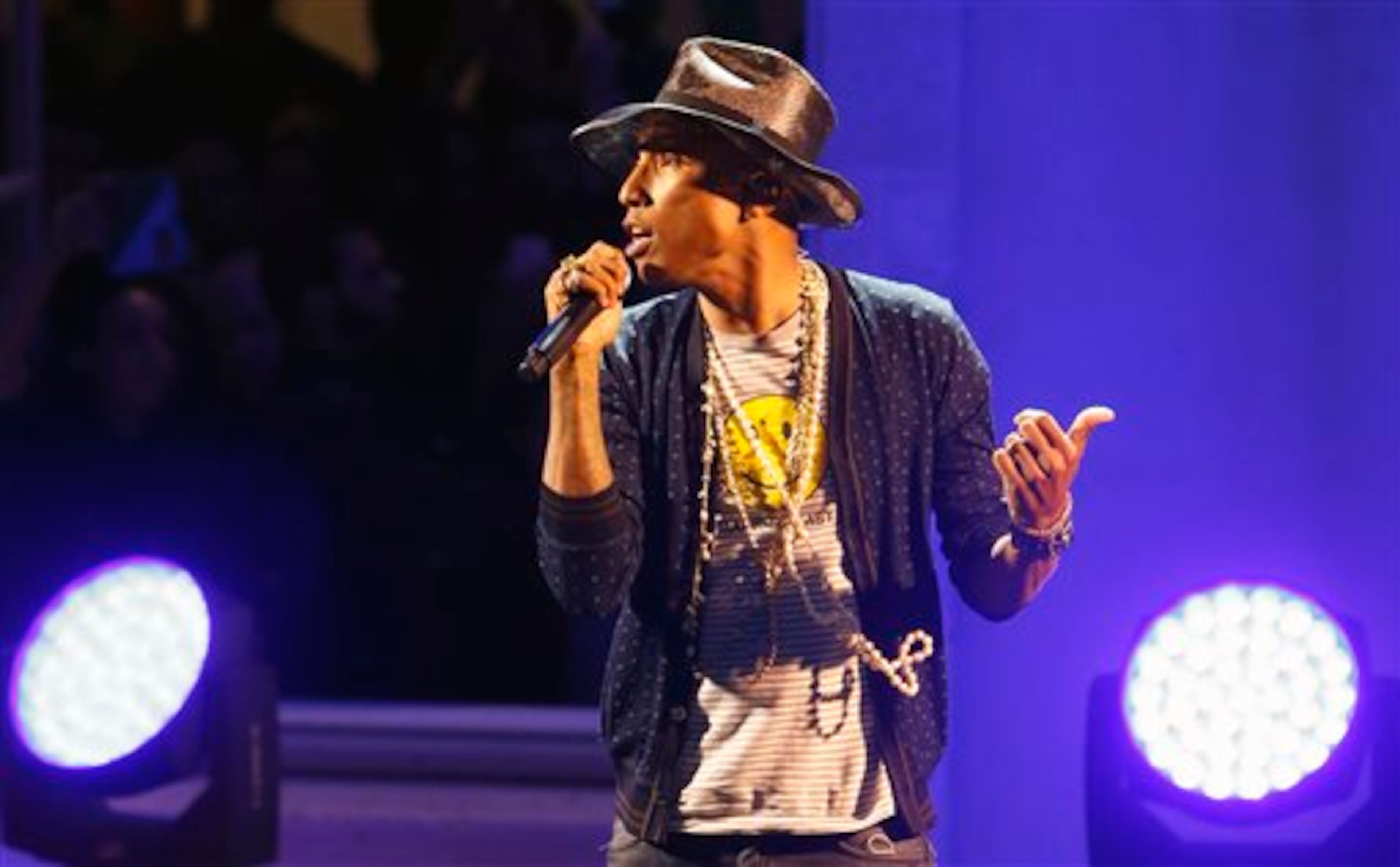 Singer Pharrell Williams performs on stage during a private concert for the exhibition "GIRL" at the Perrotin Gallery in Paris, Monday, May 26, 2014. Williams curated an exhibition encompassing around 40 art pieces, presenting their visions of femininity, muses, female creativity and freedom. The show opens on May 27 and runs through June 27. (AP Photo/Francois Mori)